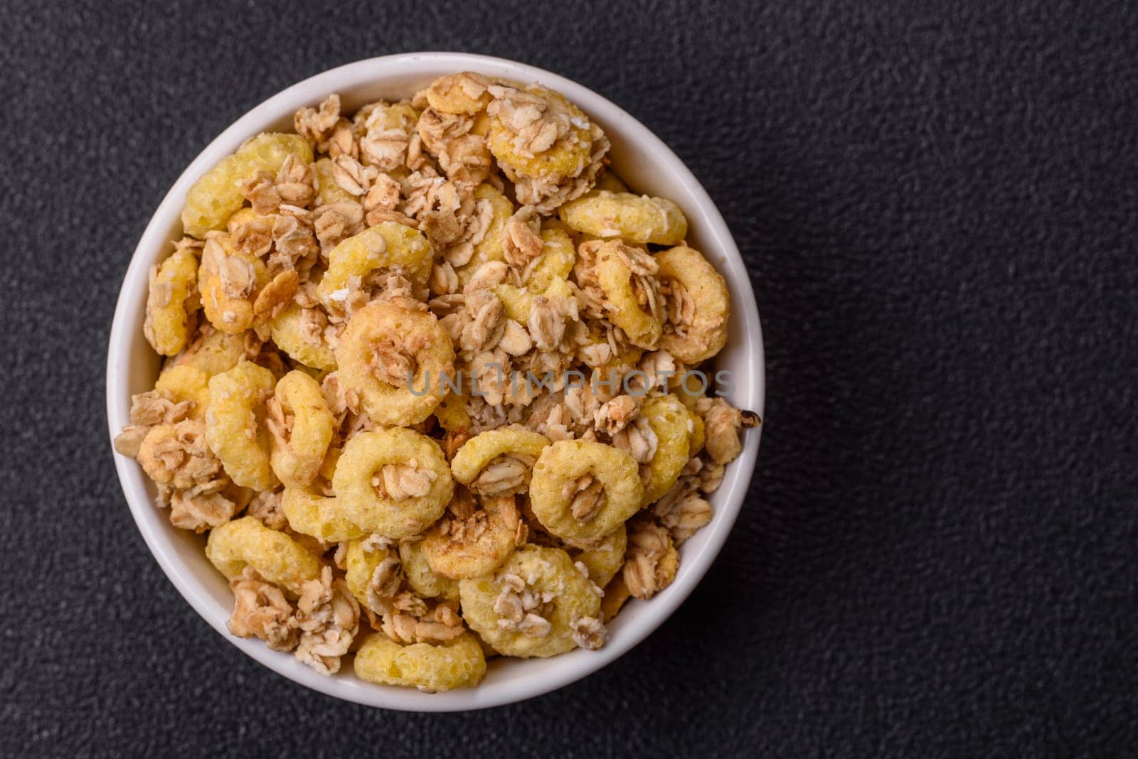 Flakes, chocolate balls and dried fruit for a hearty breakfast. Granola with chocolate flakes