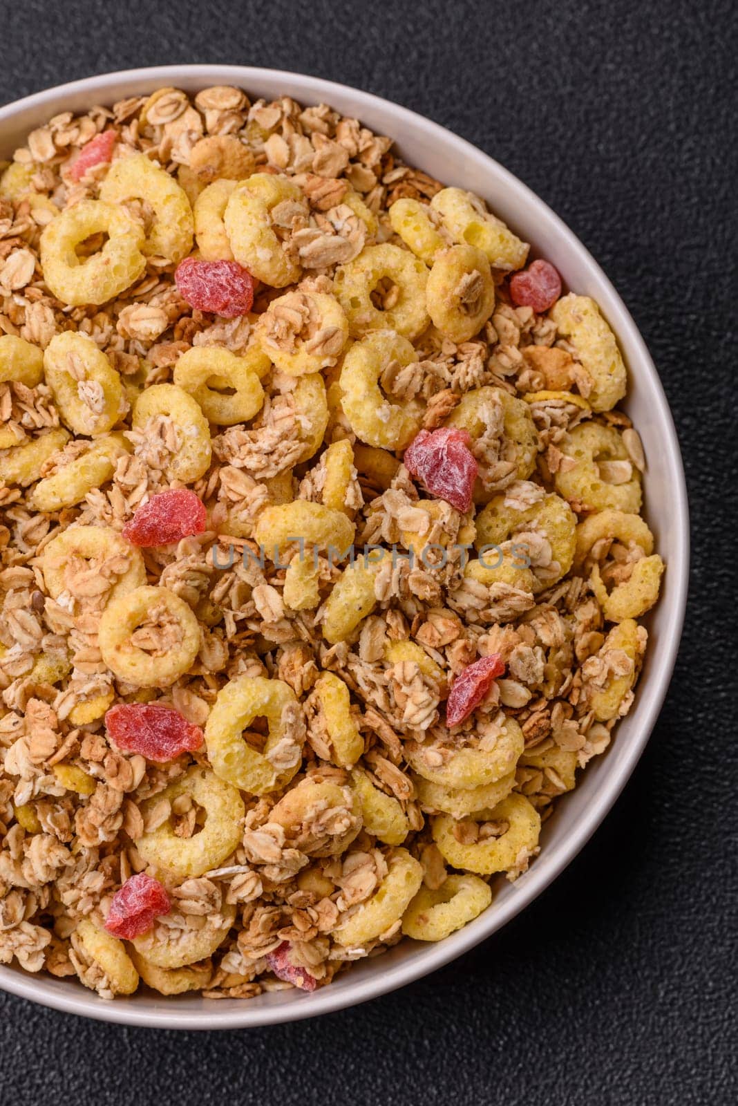 Flakes, chocolate balls and dried fruit for a hearty breakfast. Granola with chocolate flakes