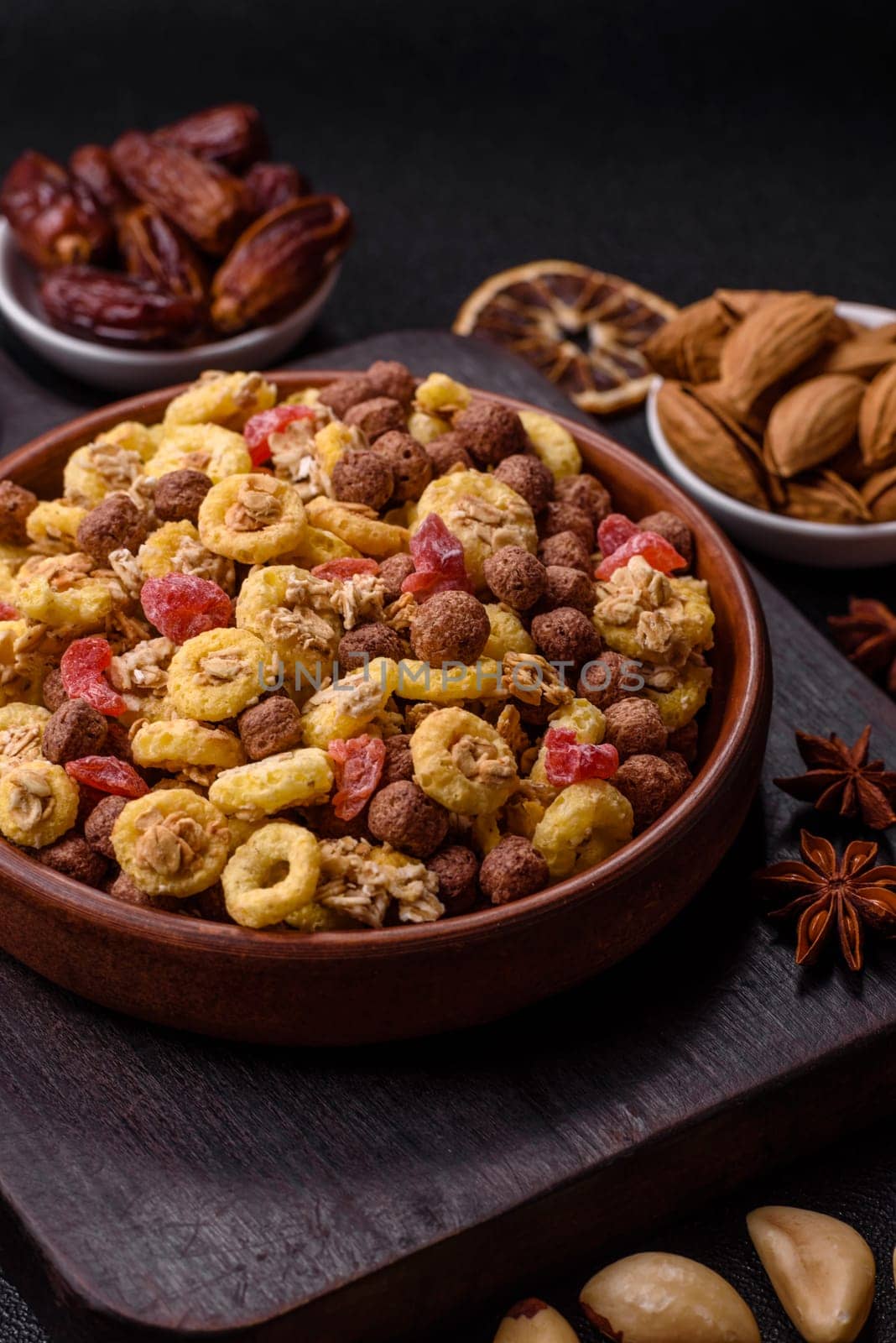 Flakes, chocolate balls and dried fruit for a hearty breakfast. Granola with chocolate flakes