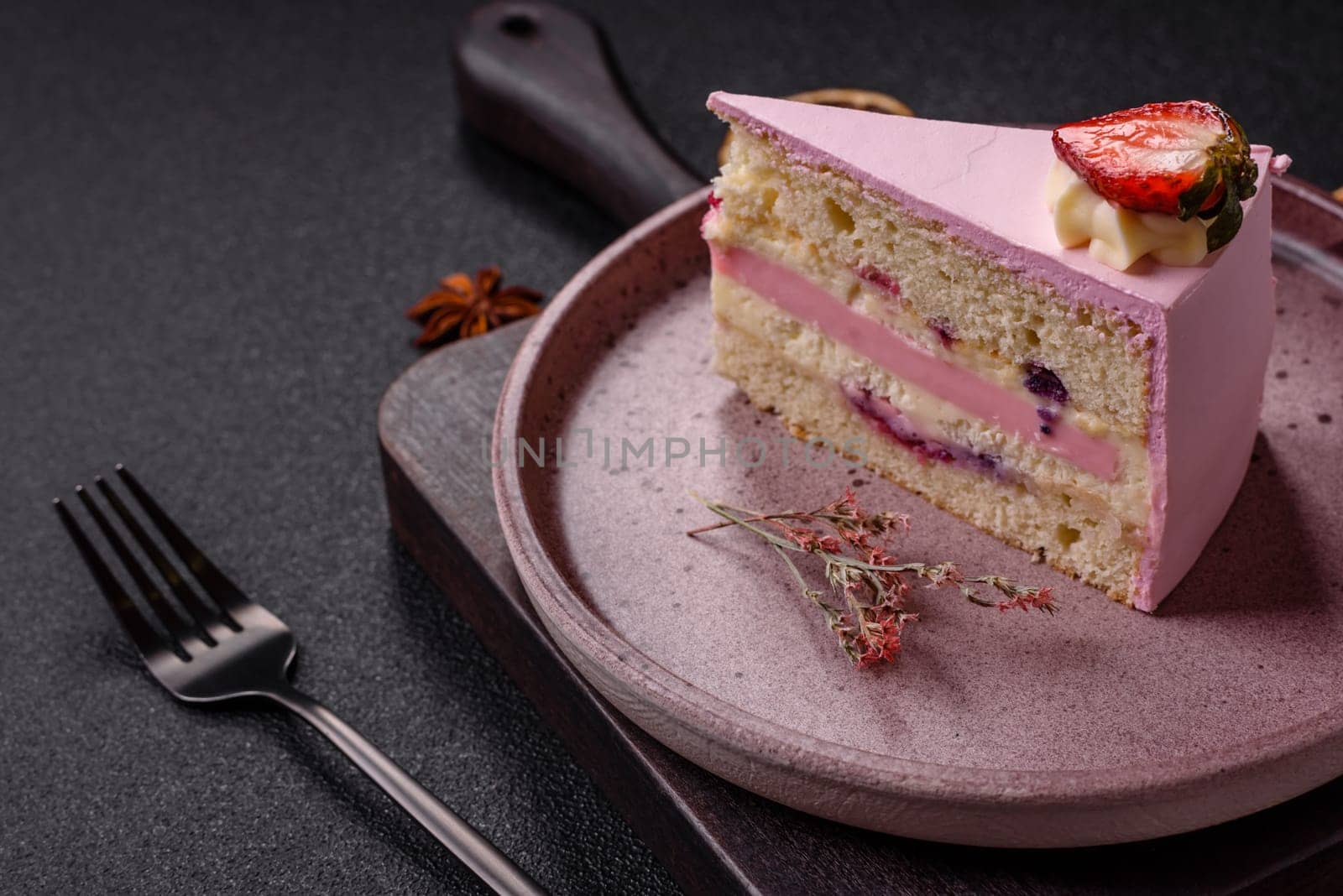 A slice of pink colored puff cake for a birthday celebration. Sweets to celebrate a wedding or valentine's day