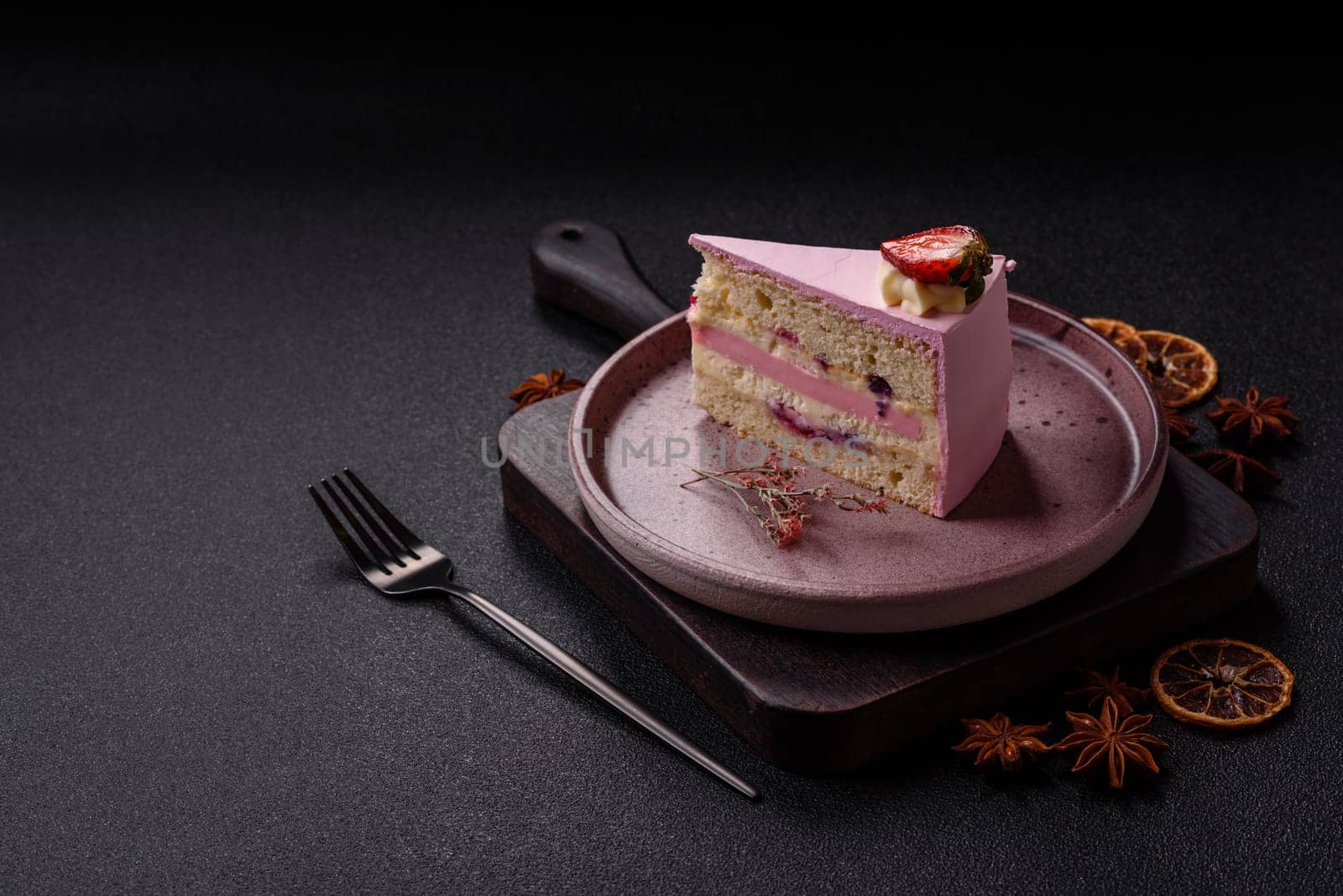 A slice of pink colored puff cake for a birthday celebration. Sweets to celebrate a wedding or valentine's day
