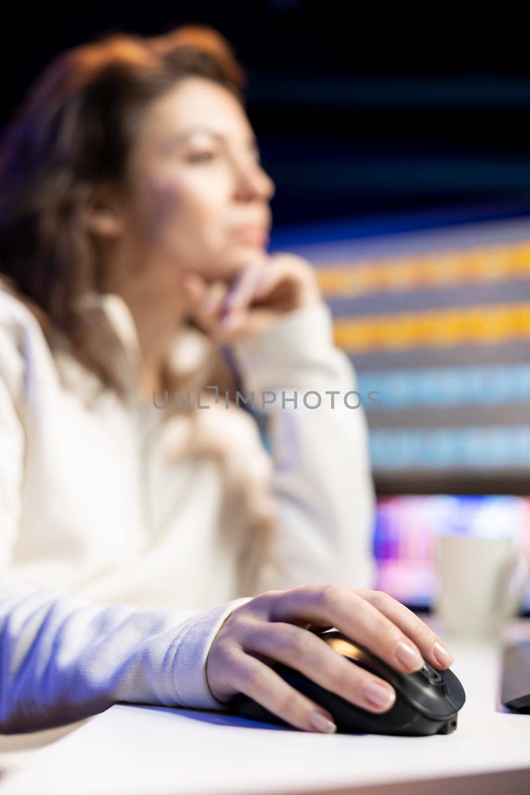 Content specialist working in graphic design media company, selecting best editorial pictures for social media post, focus on mouse. Expert editing photos in advertising agency office, close up shot