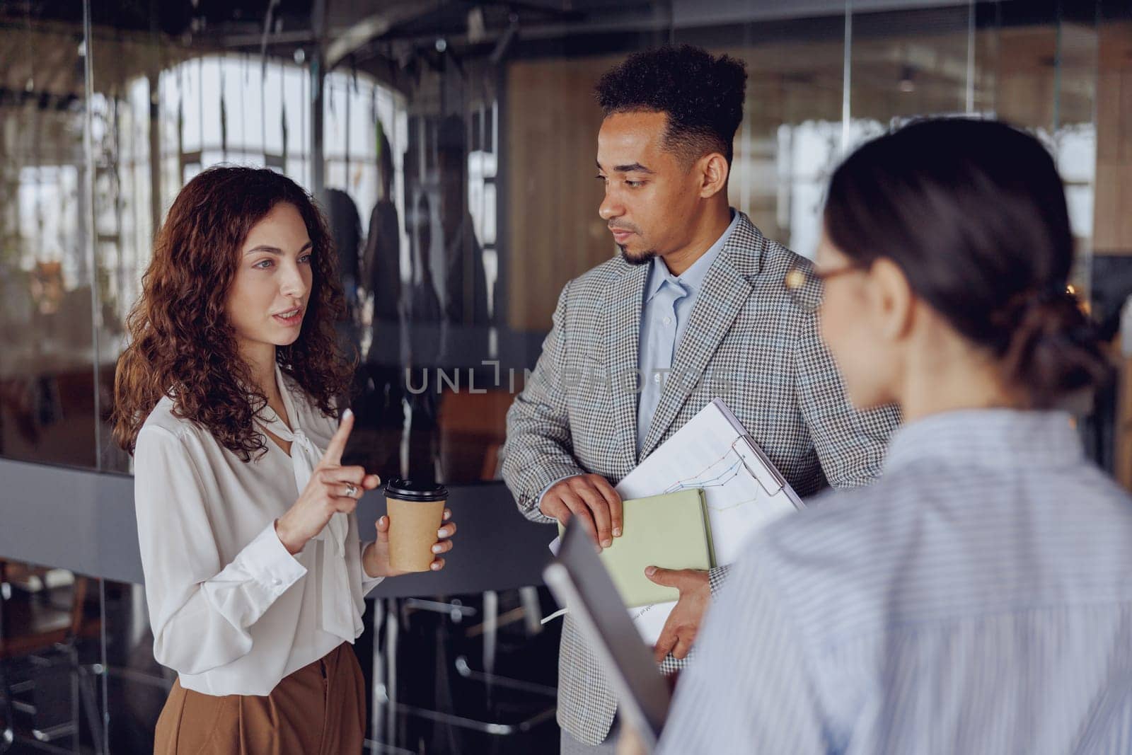 In a sleek office, professionals engage in discussions that encourage teamwork and effective communication