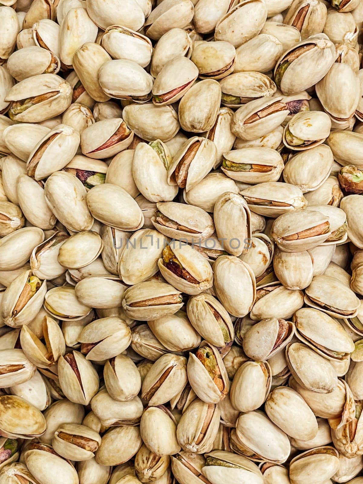 lots of ripe pistachio nuts for cooking as background