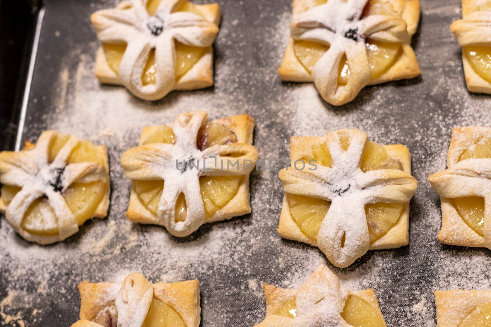 Just baked fruit puff pastry on the baking tray, dusted with powdered sugar