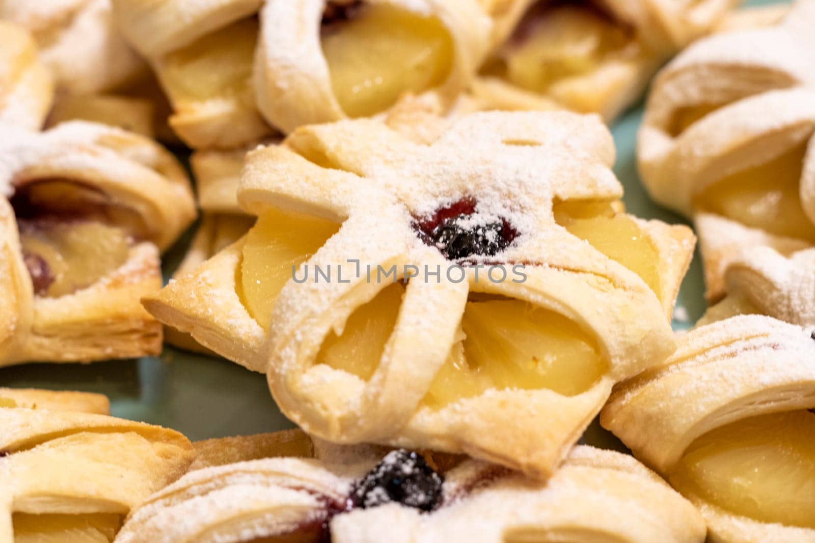 Freshly baked fruit puff pastries on the ceramic plate