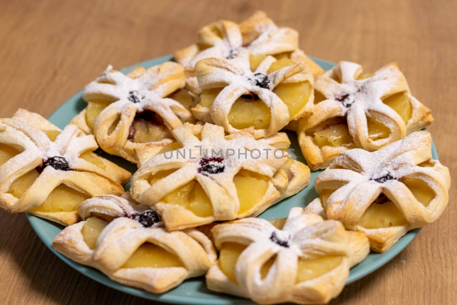 Freshly baked fruit puff pastries on the ceramic plate
