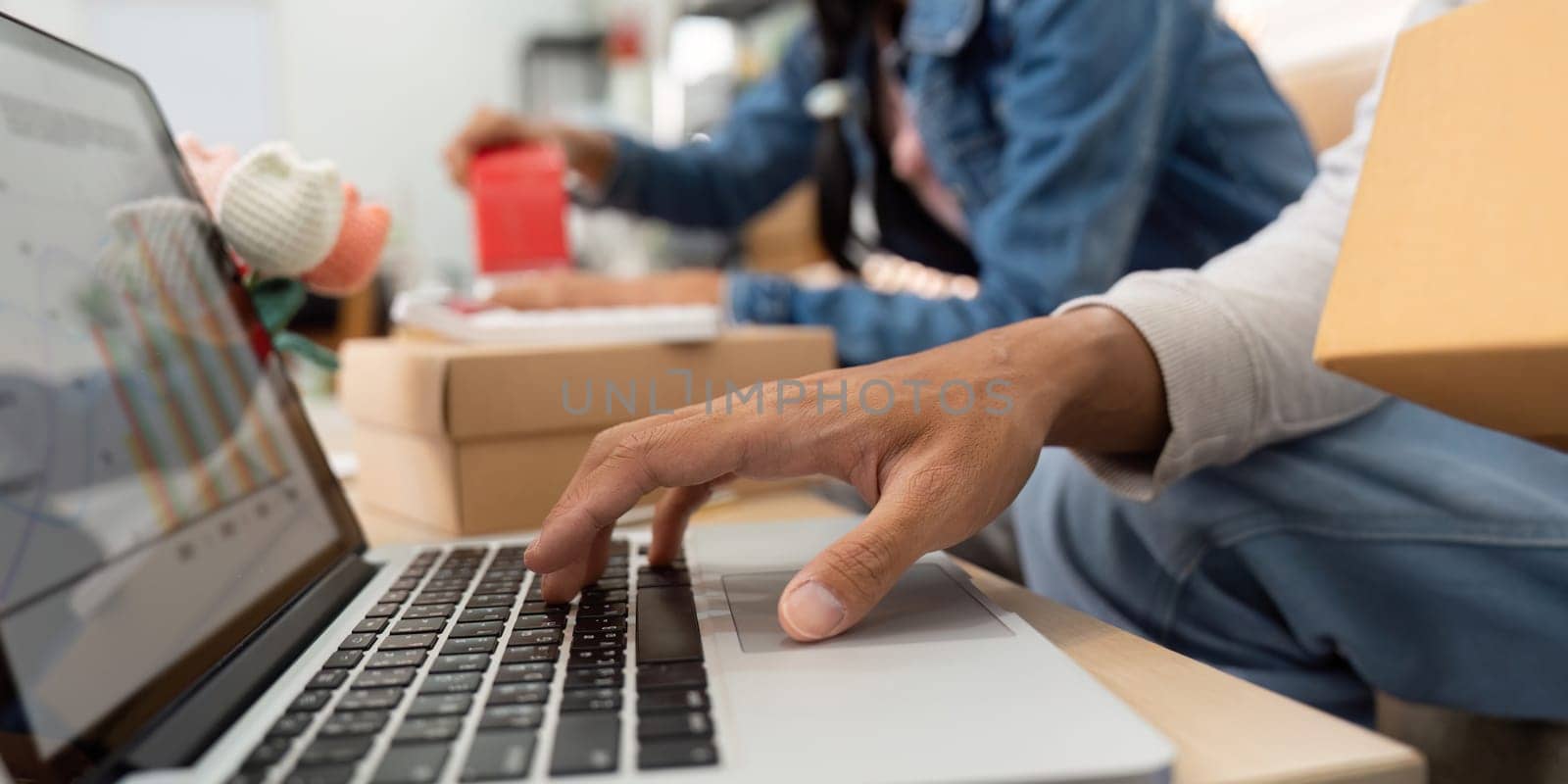 A focused individual engaged in data analysis, managing e-commerce metrics and collaborating with a partner on their home business goals.