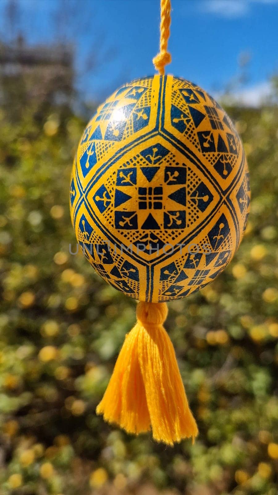 Decorative Easter eggs are displayed showcasing traditional Ukrainian pysanka designs in yellow and blue.