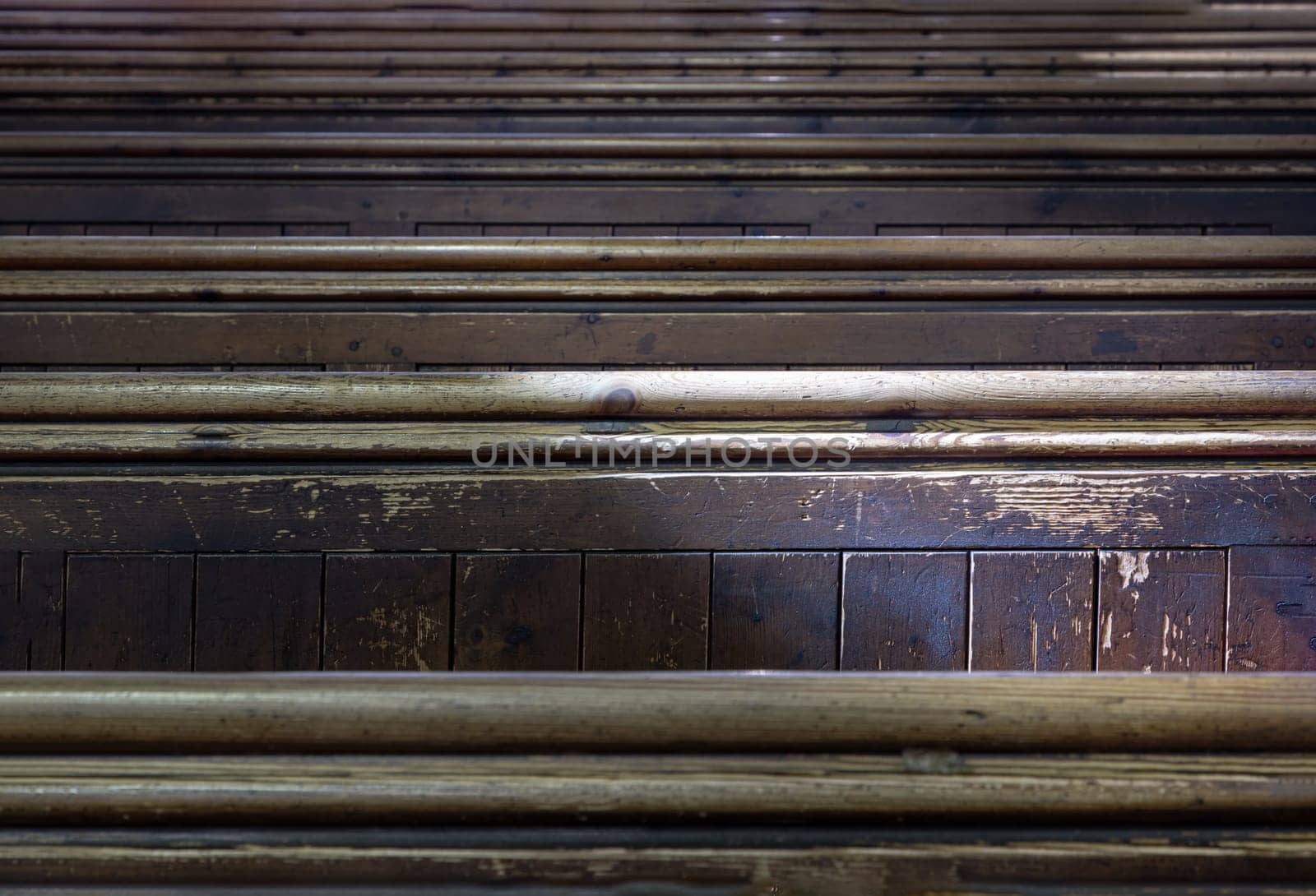 Windsor, UK - Apr 03, 2025 - Sunlight filtered through rows of Traditional church benches inside the church. View of The edge of the wooden pews, use it as your Wallpaper, Poster and Space for text, Selective focus.