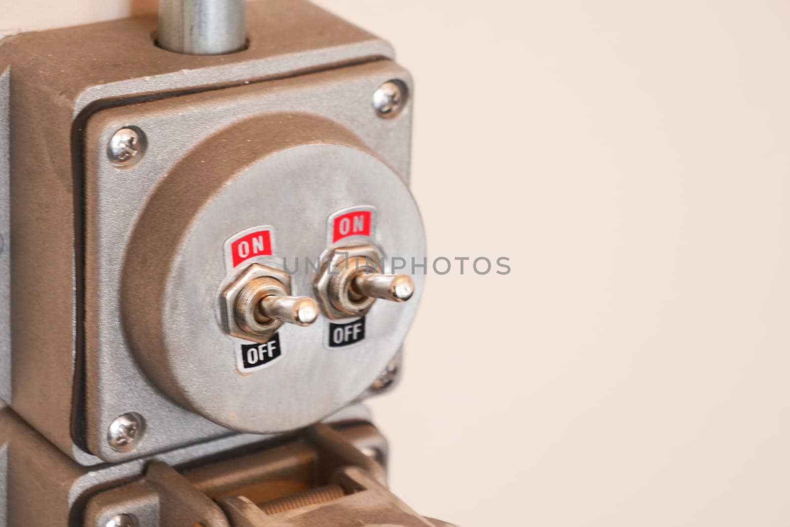 Two toggle switches on a panel show their on and off positions clearly.