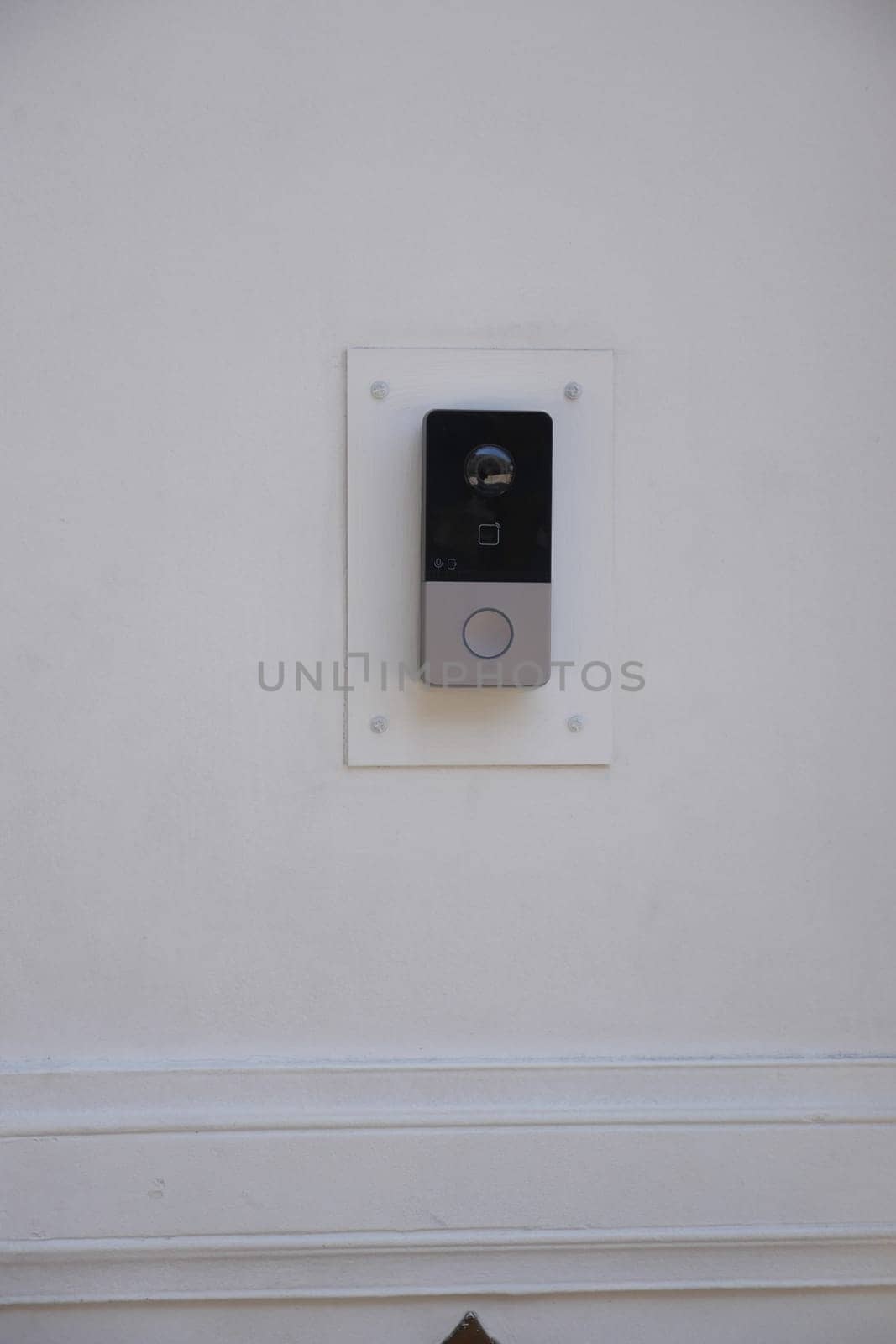 A sleek doorbell installation on a clean, white wall enhances modern decor.