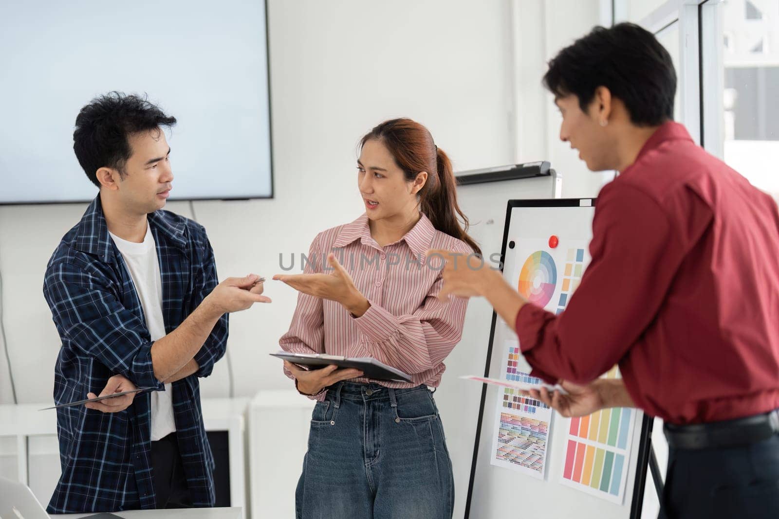 Amidst varying perspectives, the team engages in a constructive dialogue, showcasing their commitment to collaborative problem-solving in a design-centered discussion.