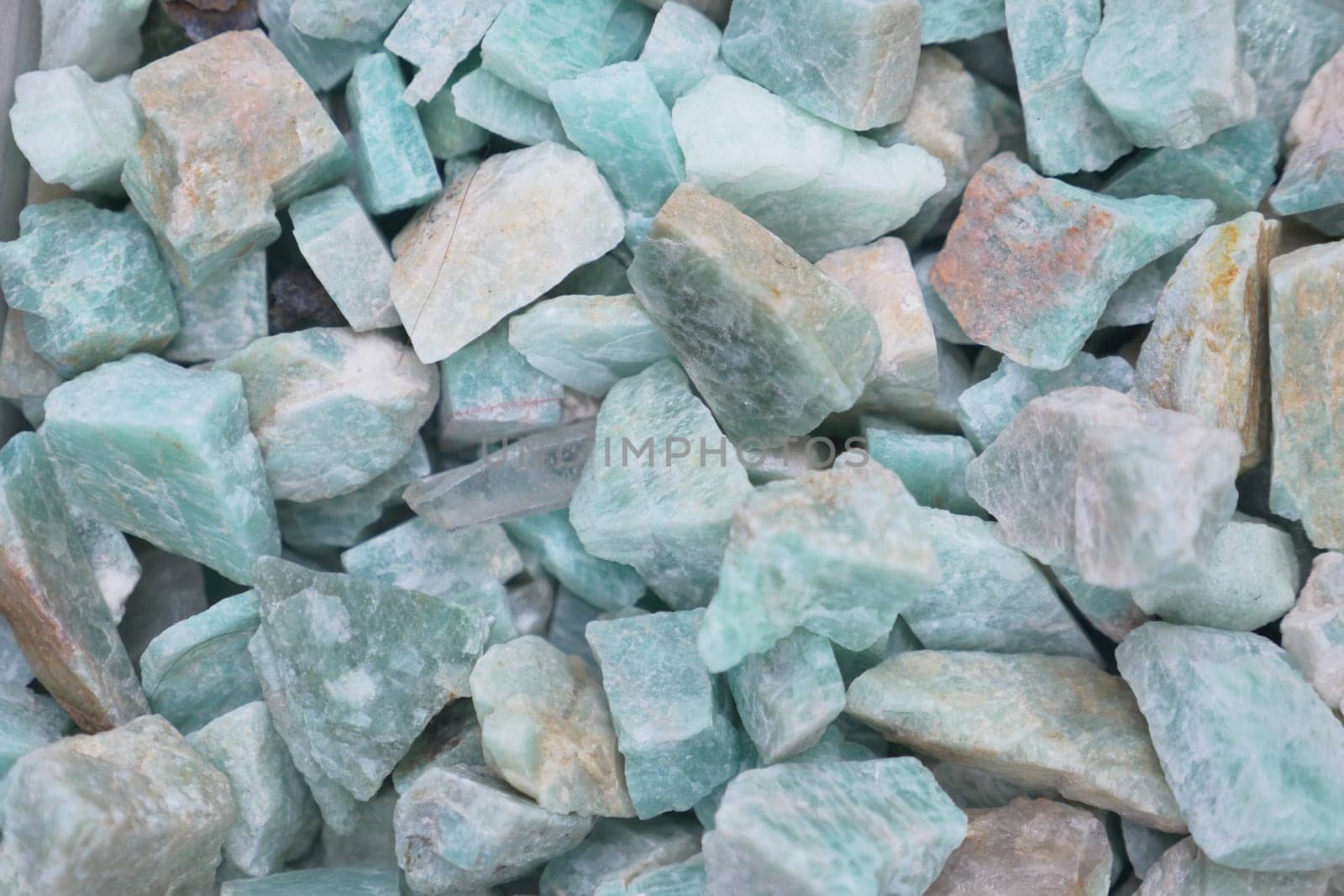 Aquamarine crystals of various sizes are scattered evenly, reflecting light.