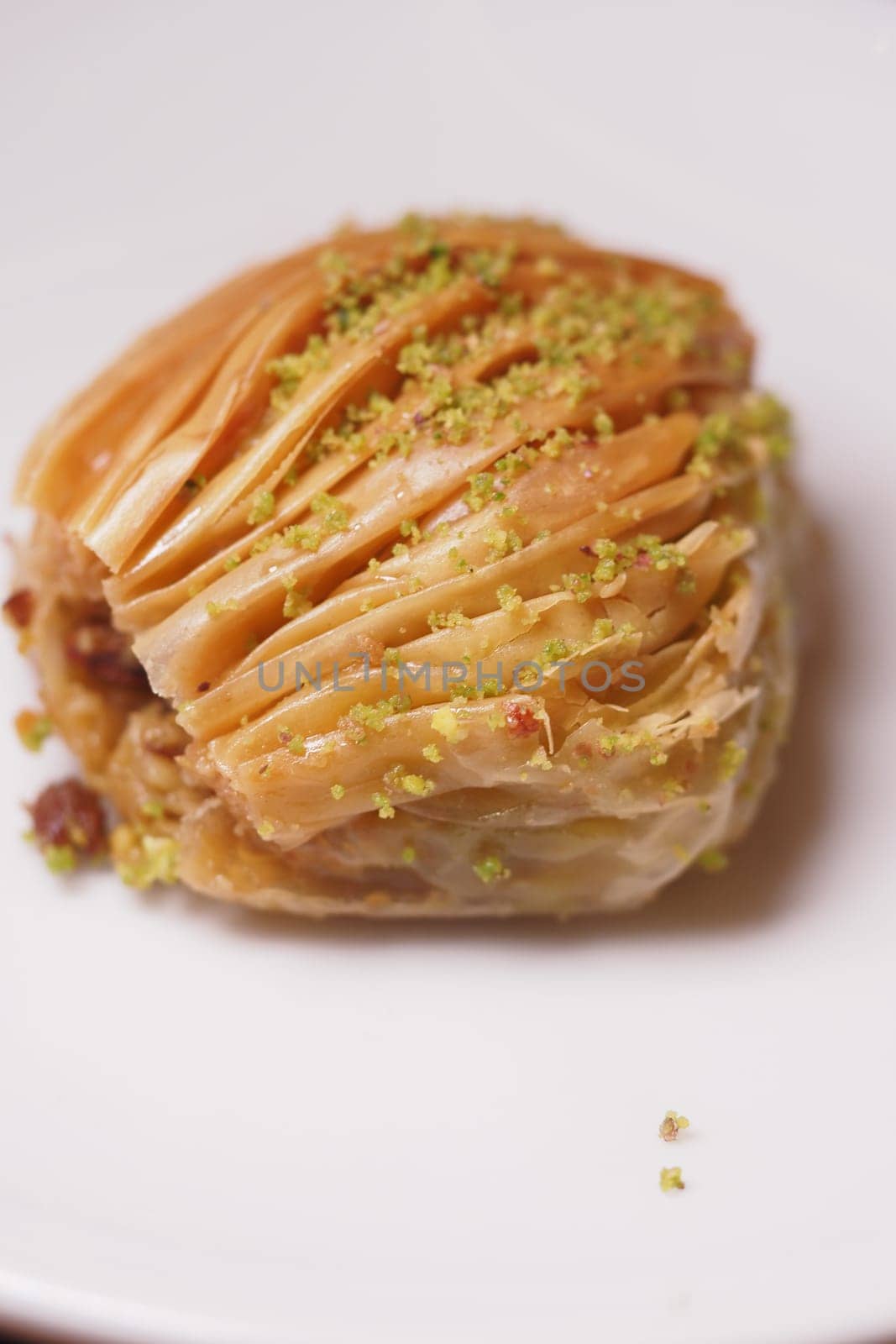 Sweet baklava with layers of pastry and nuts garnished with pistachios