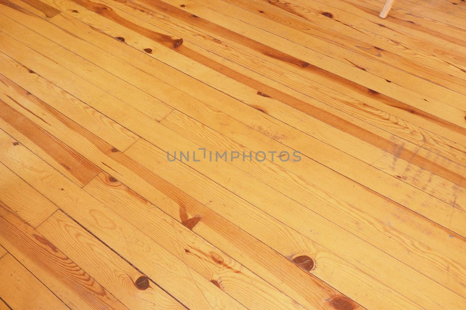 Warm, polished hardwood floor with natural grain and rich tones visible.