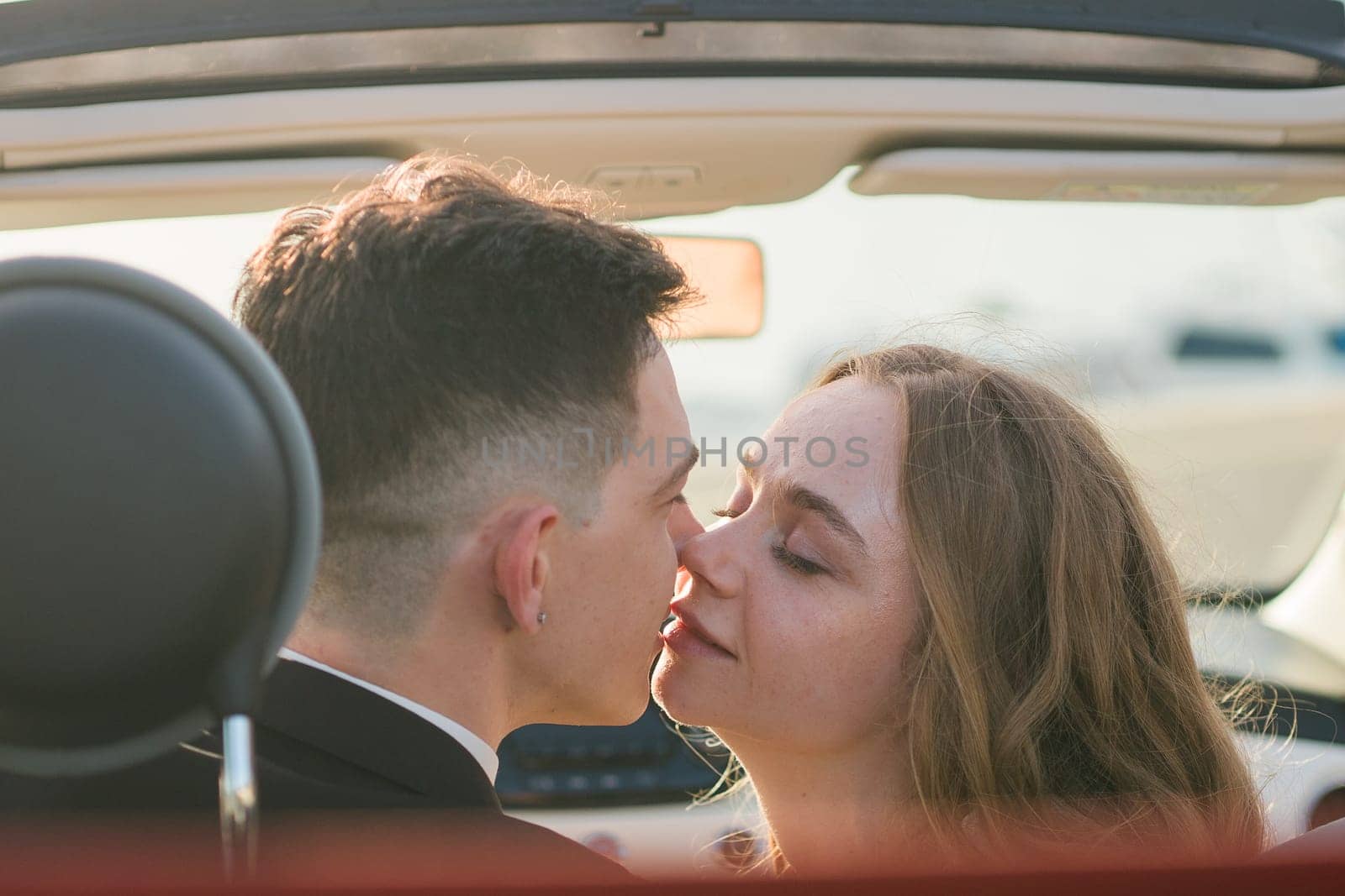 beautiful wedding couple in park. kiss and hug each other