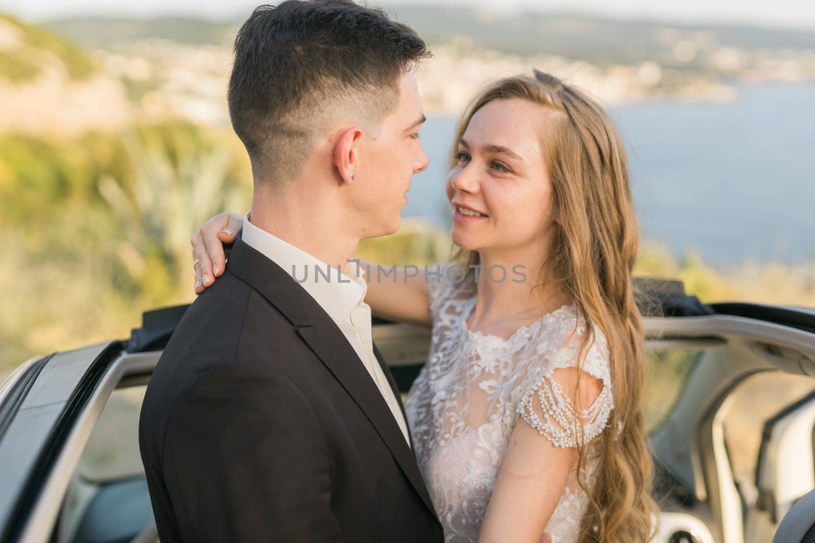 Newlyweds enjoying a quiet moment by the sea. Love, wedding and togetherness in the beginning of a shared journey.