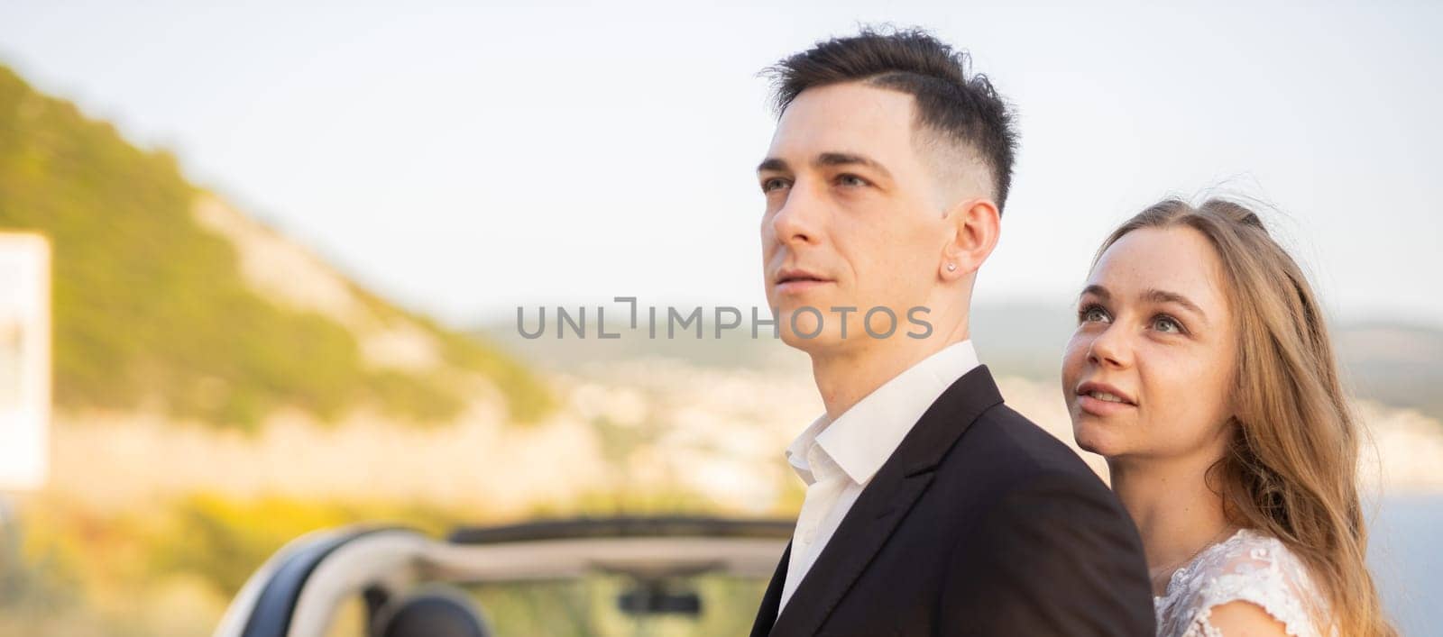 Couple embracing outdoors after wedding ceremony. Love, happiness, partnership and emotional connection in a joyful romantic moment.