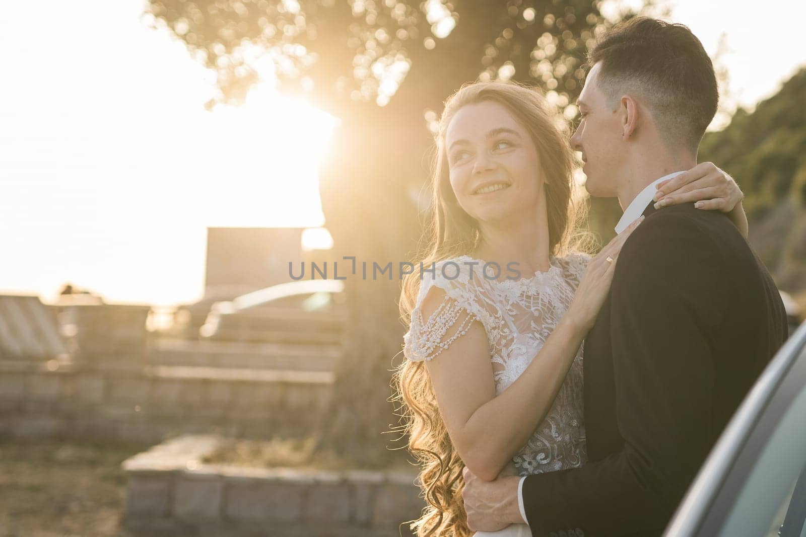 Bride and groom standing in golden sunlight after ceremony. Joy, new beginnings and emotional connection on a wedding day