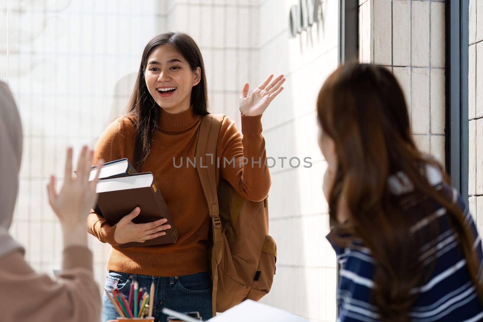 A student arrives at the cafe, excited to catch up with friends, showcasing enthusiasm and the joy of learning together.