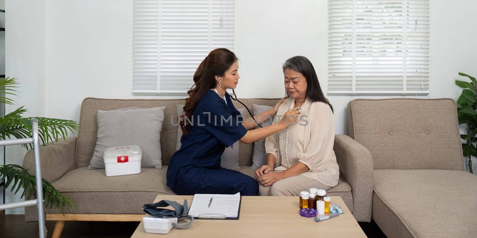 A compassionate nurse checks an elderly woman's heart sounds using a stethoscope, emphasizing the role of home healthcare in maintaining cardiovascular health.