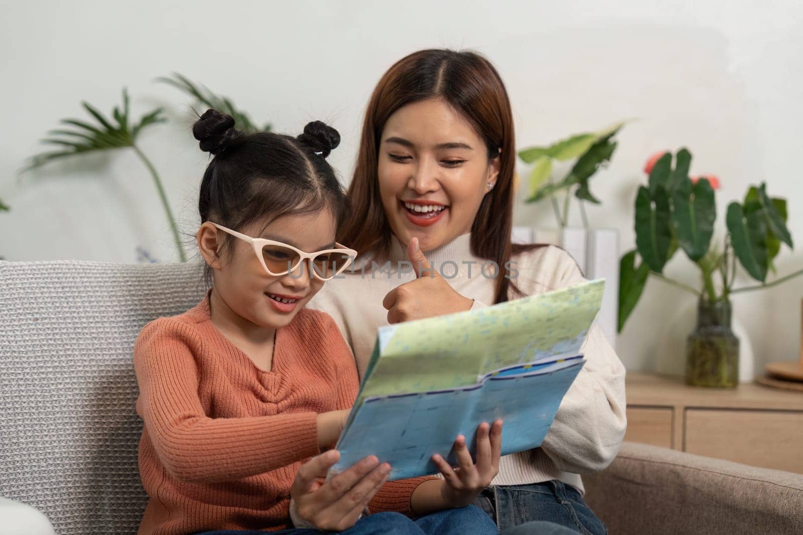 The mother and daughter look through travel documents, discussing their upcoming trip and expressing joy about their future adventures.