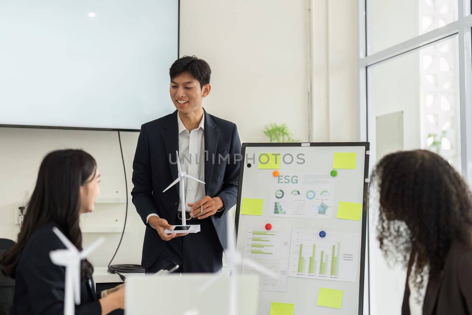 In a collaborative setting, team members examine ESG data, discussing insights and strategies for promoting sustainable growth within the organization.