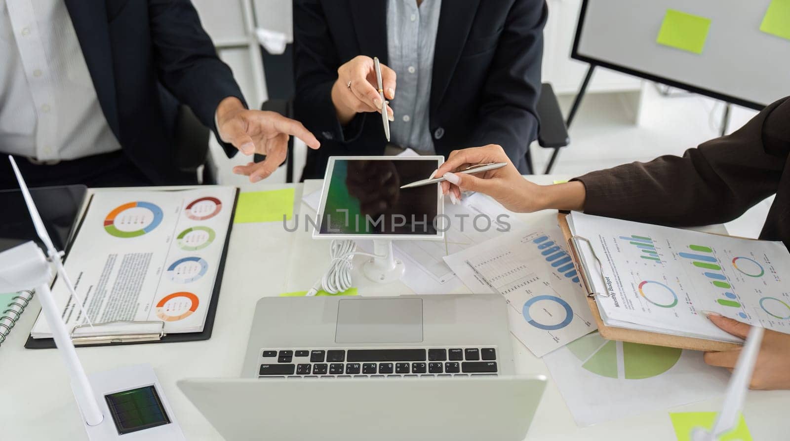 A collaborative session where the team analyzes data and discusses strategies for implementing sustainable practices in their business projects.
