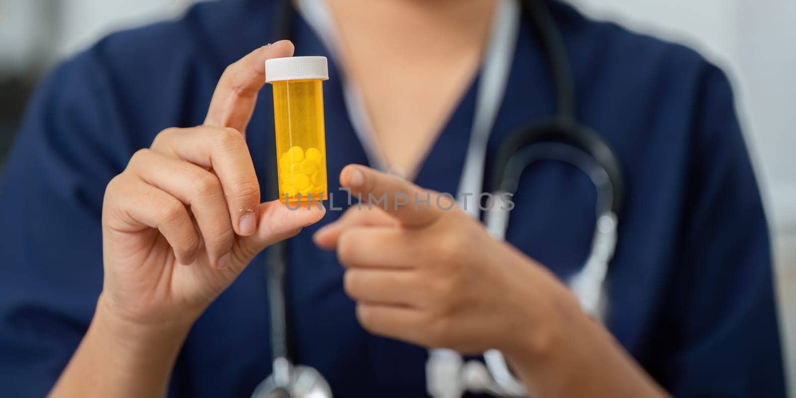 A healthcare professional presents a prescription bottle to a patient, highlighting the importance of medication management and patient education in healthcare.