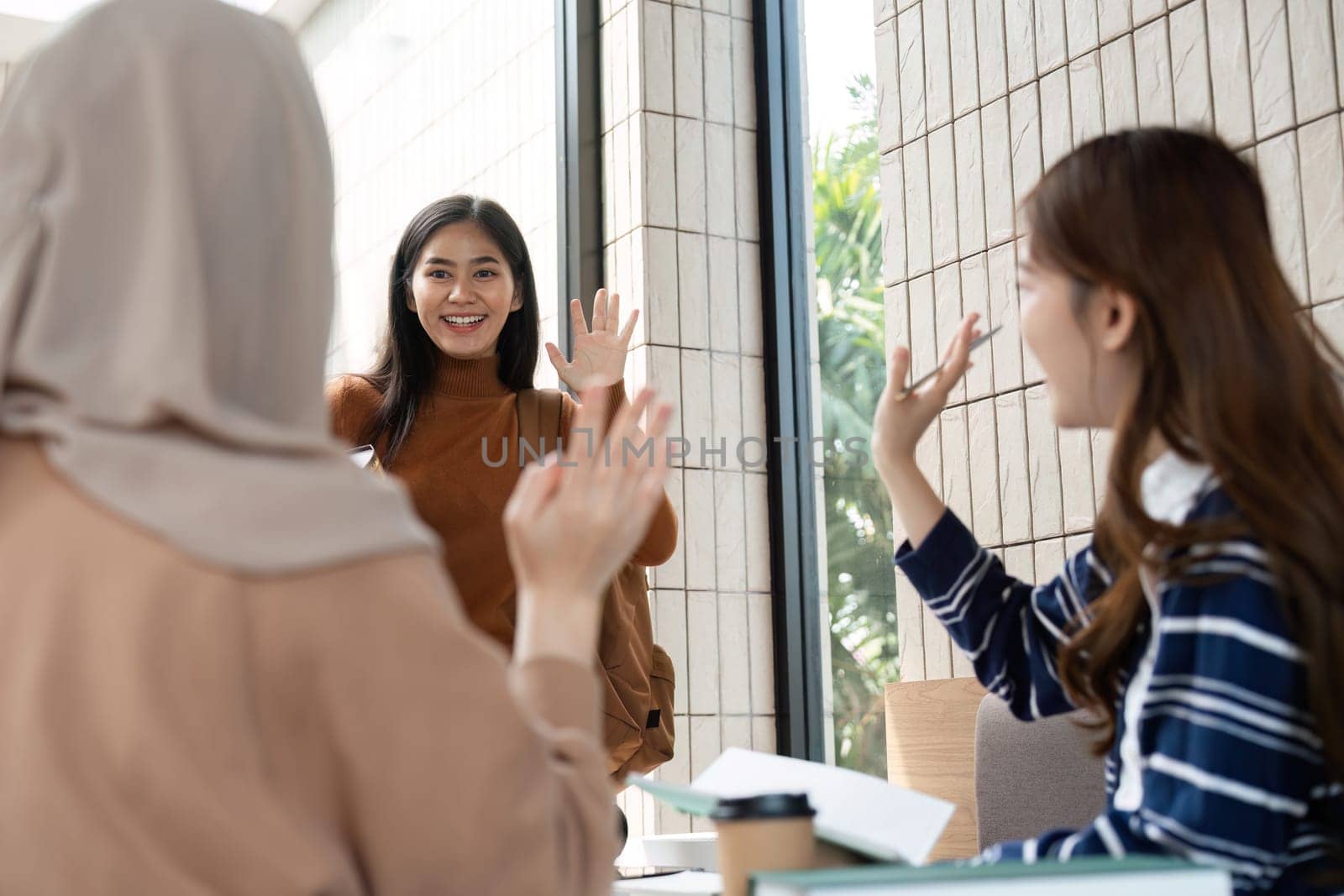 Three friends meet at a cozy cafe to discuss school projects, enjoy their favorite beverages, and reconnect during a study session, highlighting the joy of camaraderie.