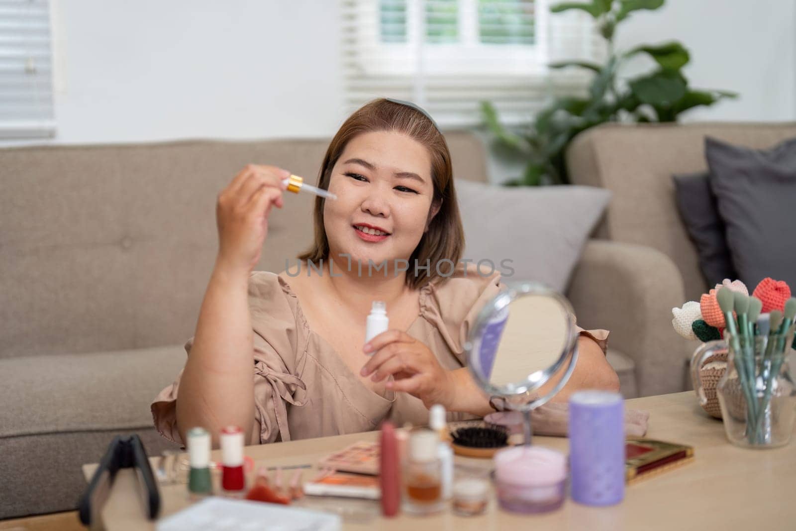 In a relaxed atmosphere, a woman examines a beauty oil with enthusiasm, showcasing her passion for skincare and beauty routines.