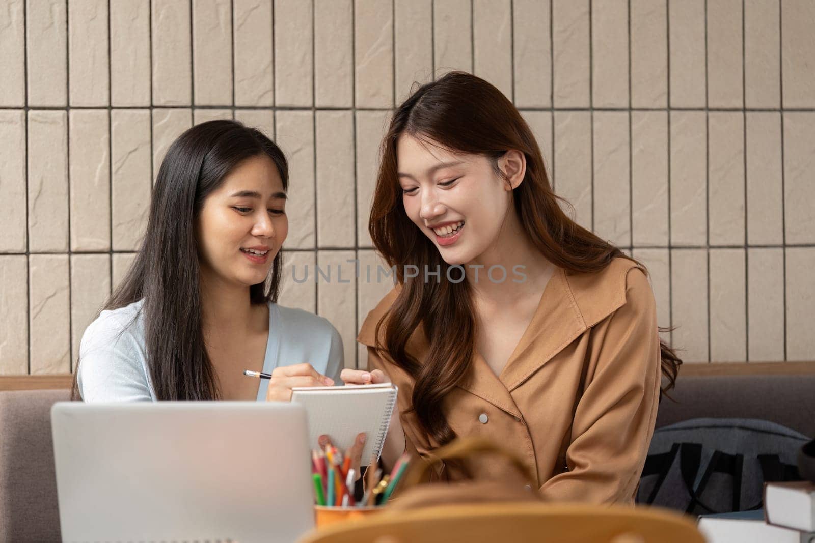 In an inviting cafe, these students share creative insights and practical knowledge, making their study session both fun and informative.