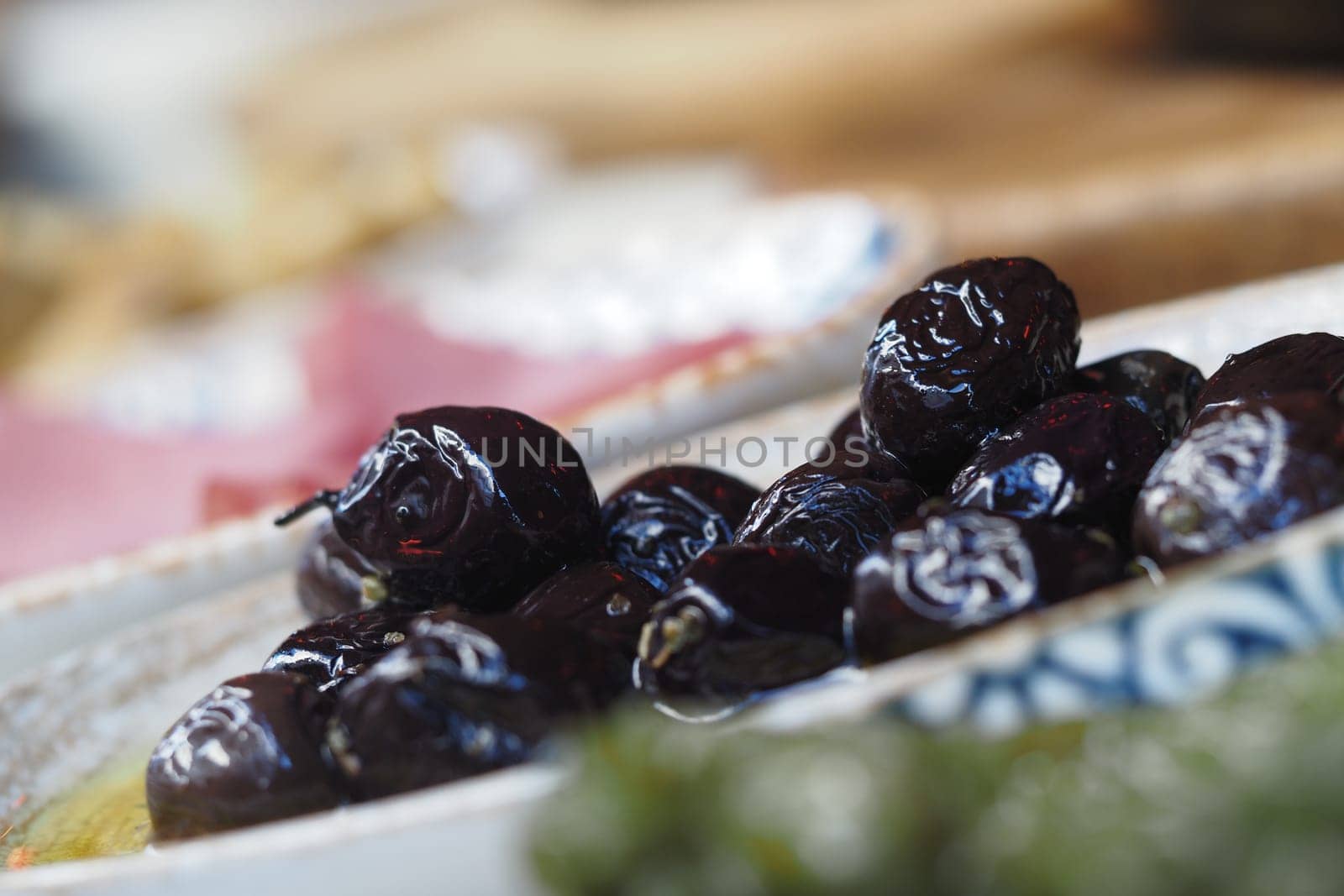 Platter features vibrant black olives ready for enjoyment and sharing