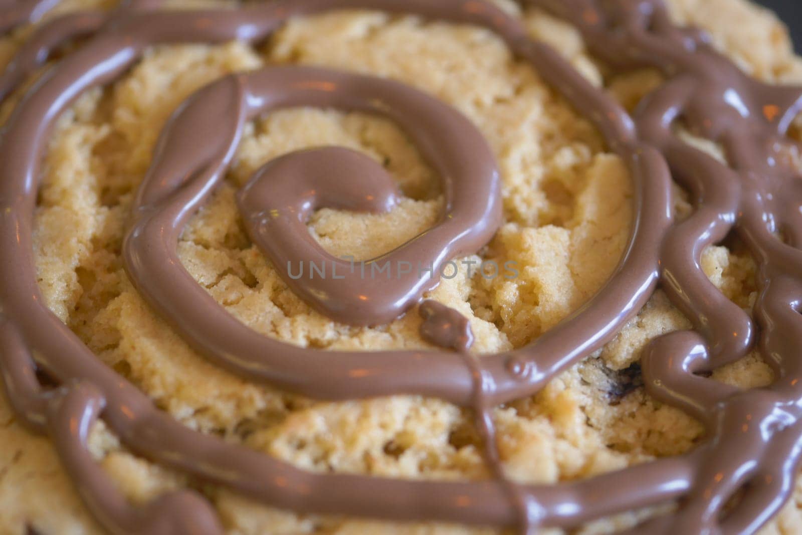 A decadent cookie topped with a rich chocolate swirl design
