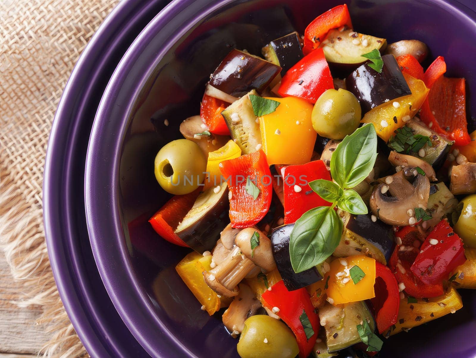 A vibrant salad filled with diced bell peppers, eggplant, mushrooms, and olives is beautifully presented in a deep bowl. Fresh herbs garnish the dish, showcasing the abundant colors and fresh flavors.