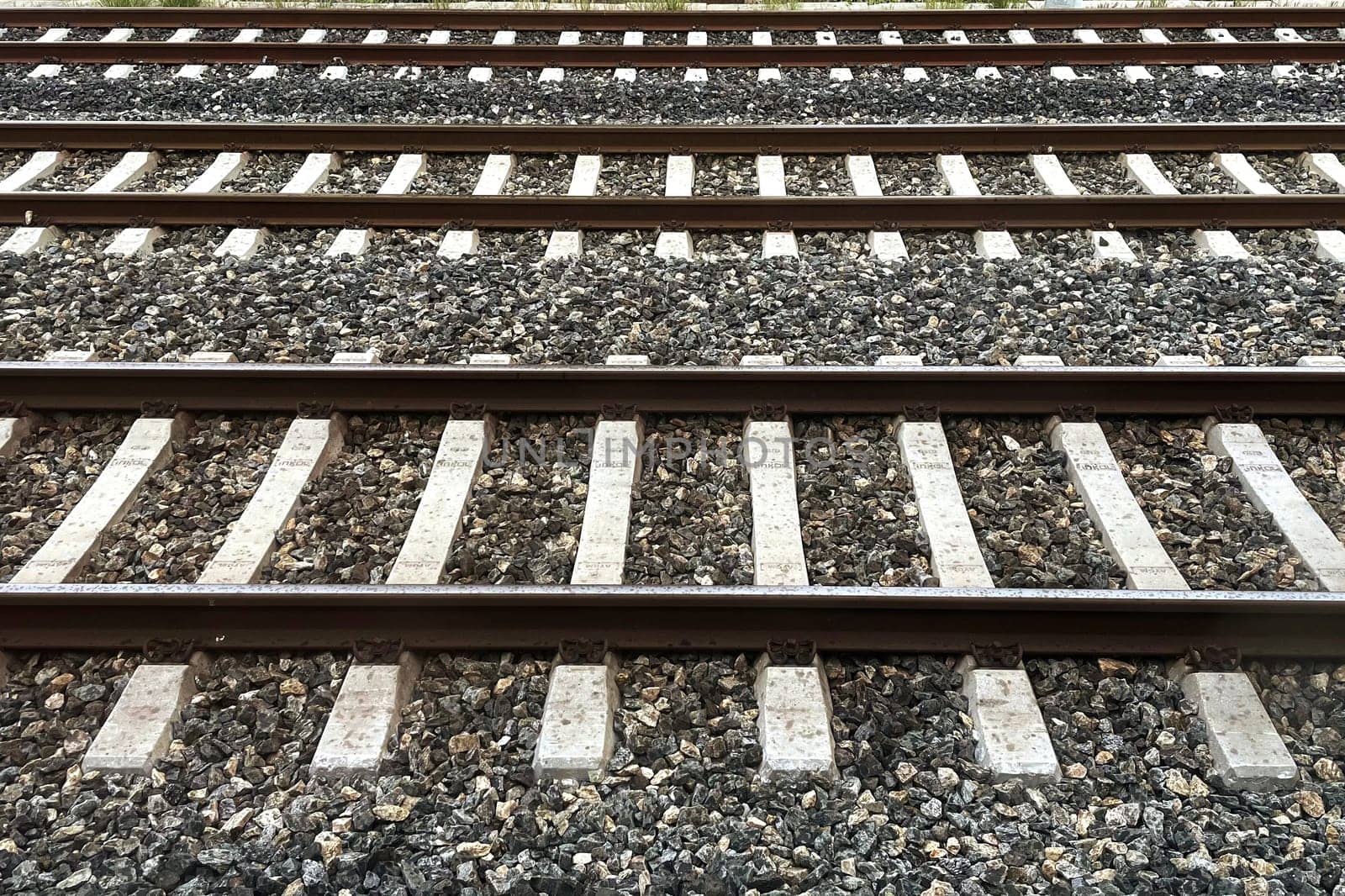 Railway Tracks Leading to the Horizon.A scenic view of multiple railway tracks stretching into the distance, emphasizing symmetry, structure, and the essence of travel. The image highlights precision engineering and evokes a sense of journey and connection.
