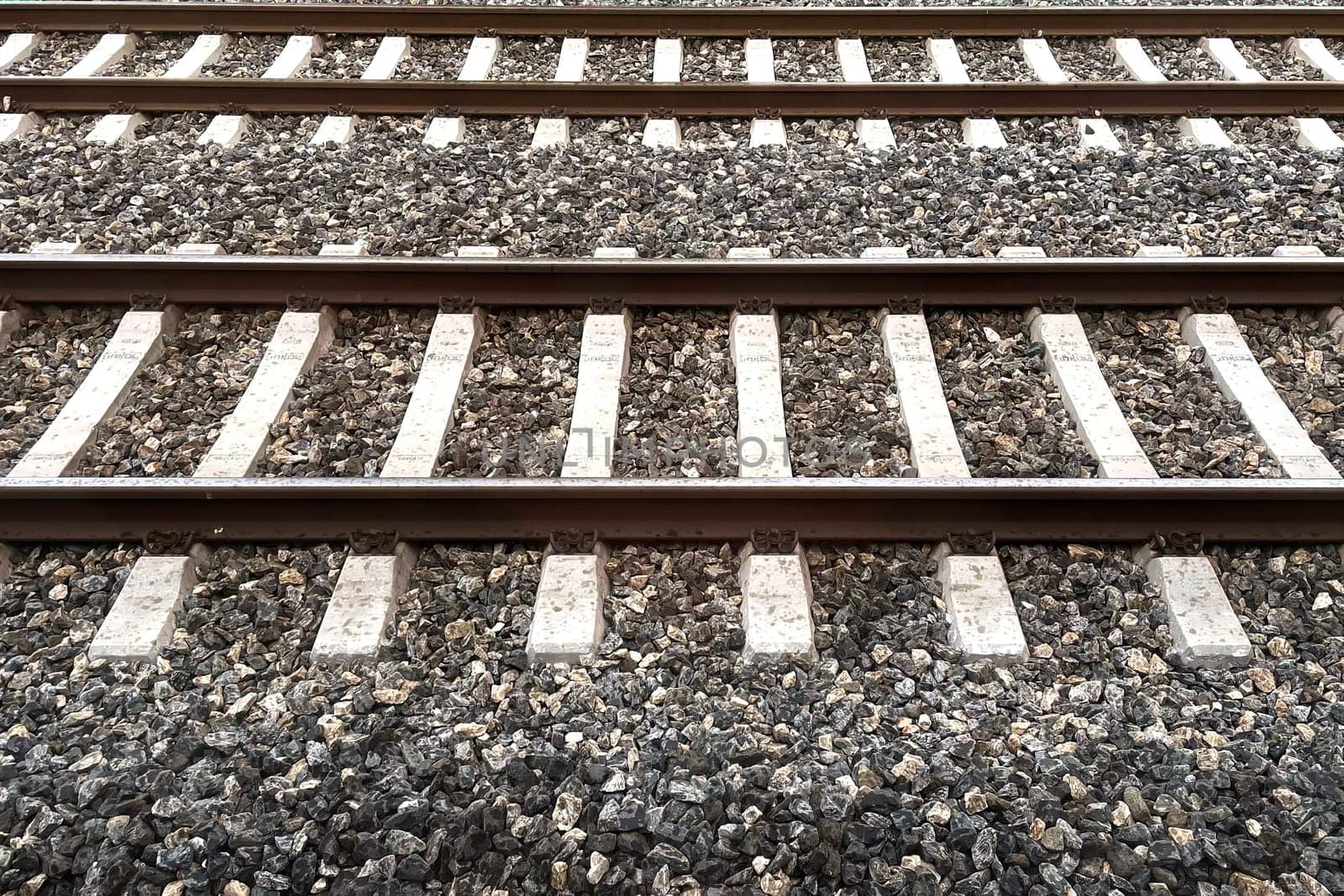 Railway Tracks Leading to the Horizon.A scenic view of multiple railway tracks stretching into the distance, emphasizing symmetry, structure, and the essence of travel. The image highlights precision engineering and evokes a sense of journey and connection.