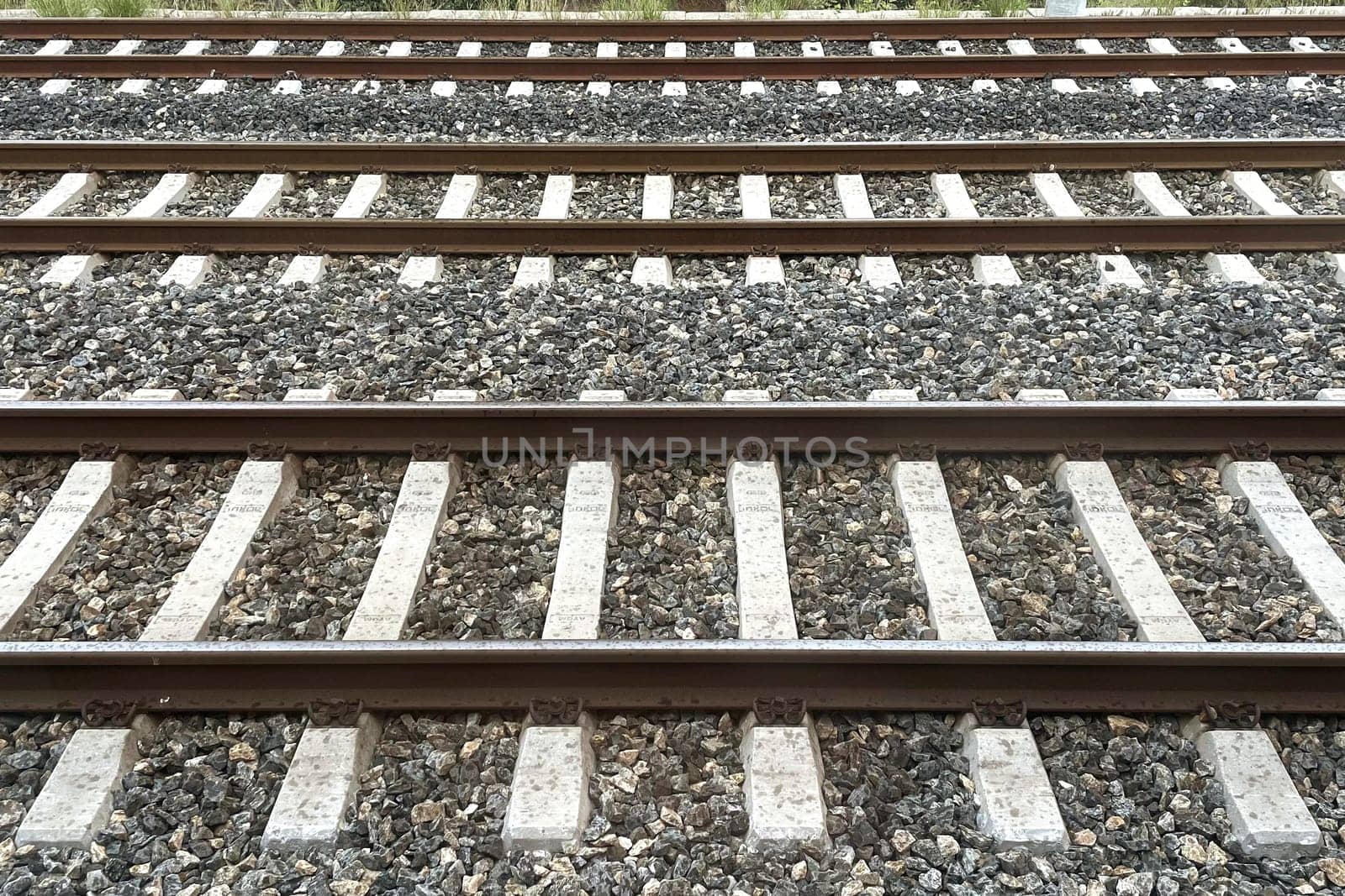Railway Tracks Leading to the Horizon.A scenic view of multiple railway tracks stretching into the distance, emphasizing symmetry, structure, and the essence of travel. The image highlights precision engineering and evokes a sense of journey and connection.