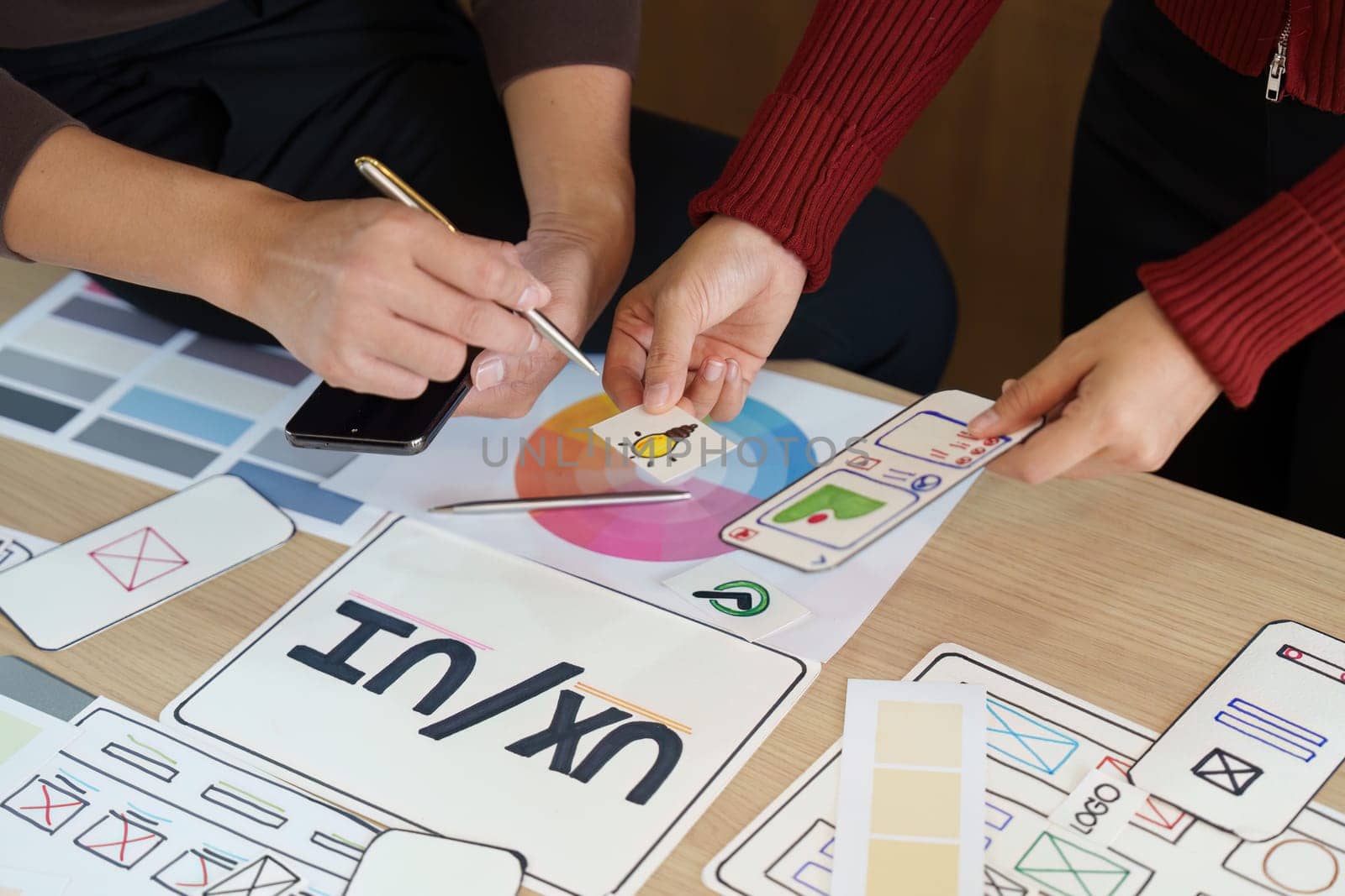 UX UI professionals delve into color palettes and design elements, fostering collaboration through visual brainstorming to enhance user experience.