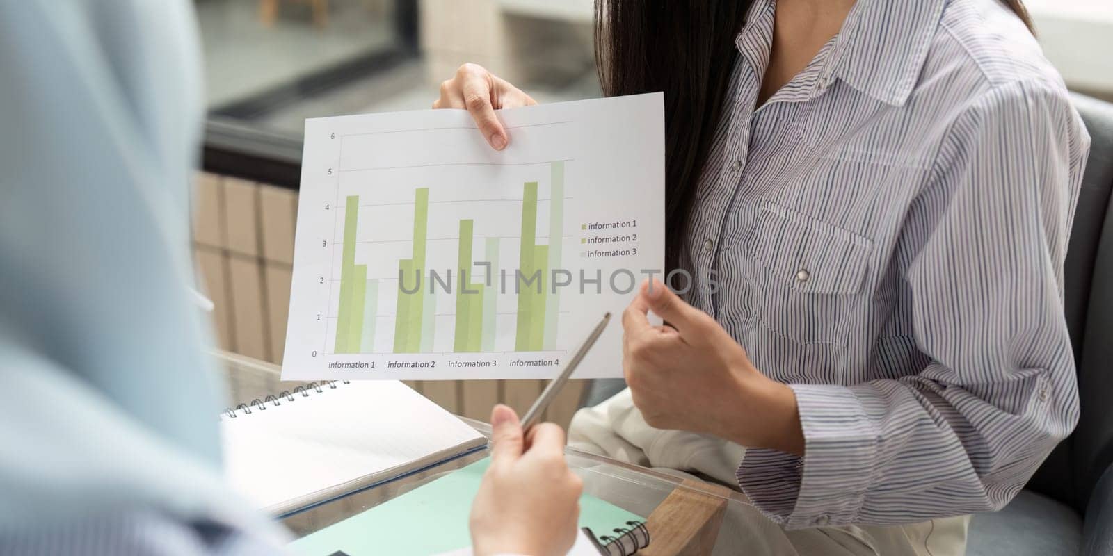 In a meeting focused on ESG strategies, the professional highlights visual data indicating progress in sustainable practices, promoting informed decisions for future actions.