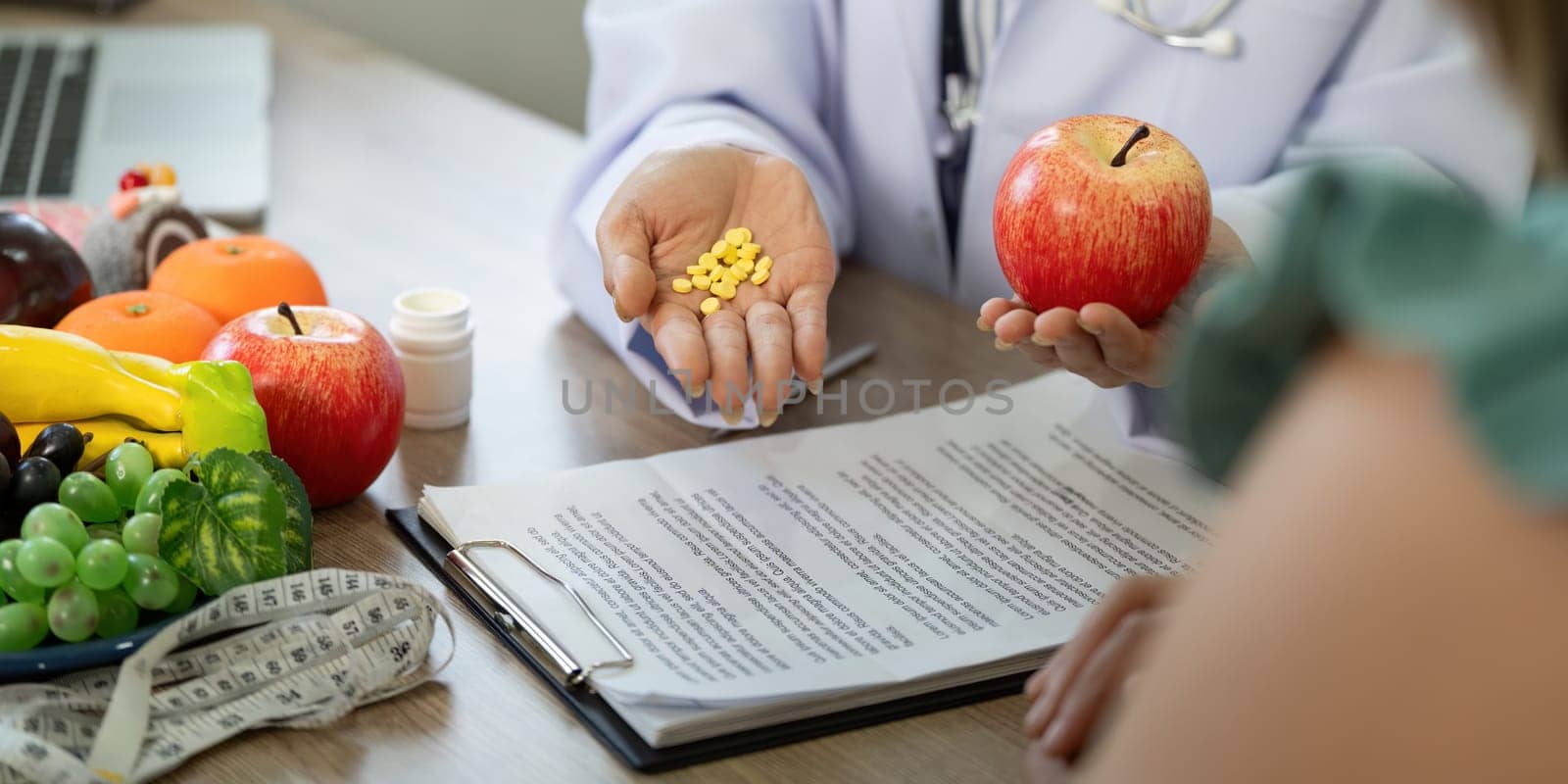 In a consultative setting, a healthcare professional compares healthy food choices with dietary supplements, guiding the patient towards informed decisions.