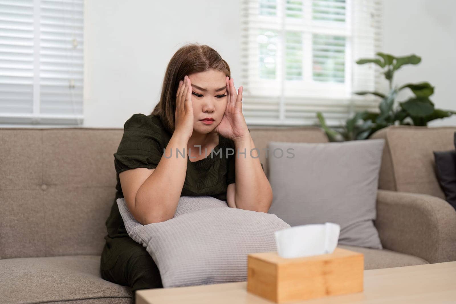 The client displays signs of distress, with her hands on her head, processing her emotions and seeking coping strategies during the session.