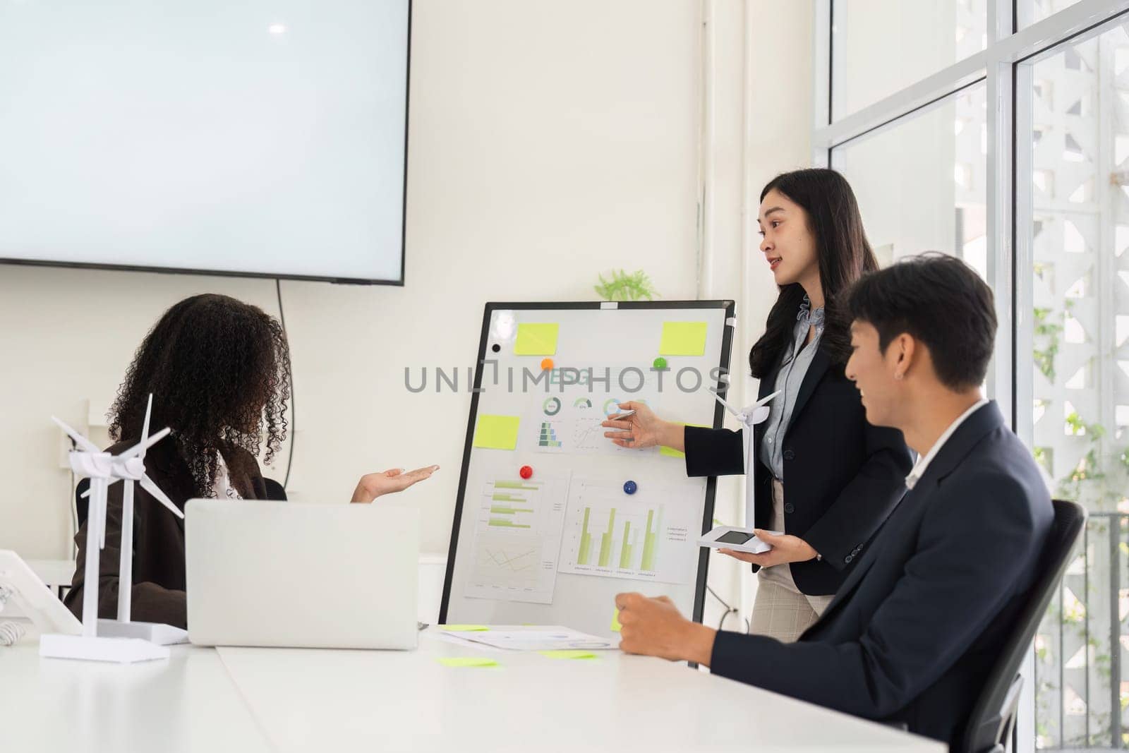 During an engaging team meeting, one member presents insights about ESG practices, promoting awareness of environmental advocacy.