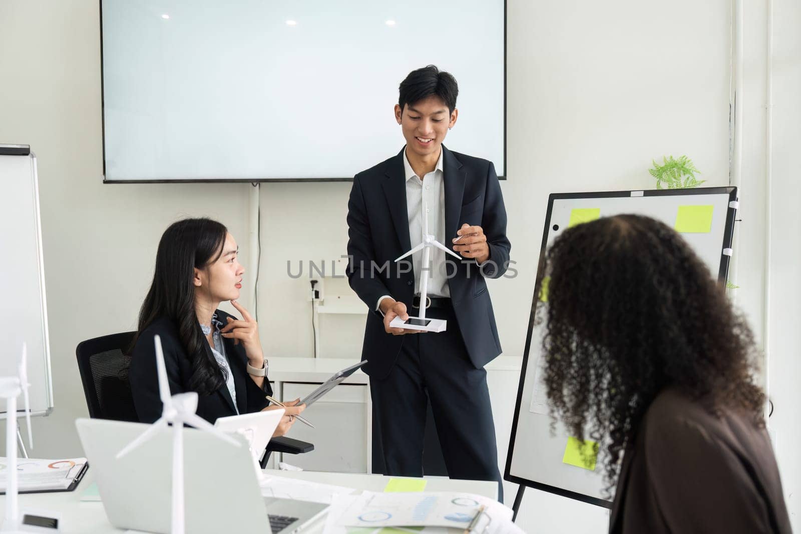 A dedicated team is engaged in a brainstorming session about sustainable practices for ESG initiatives, showcasing collaboration and innovative thinking.