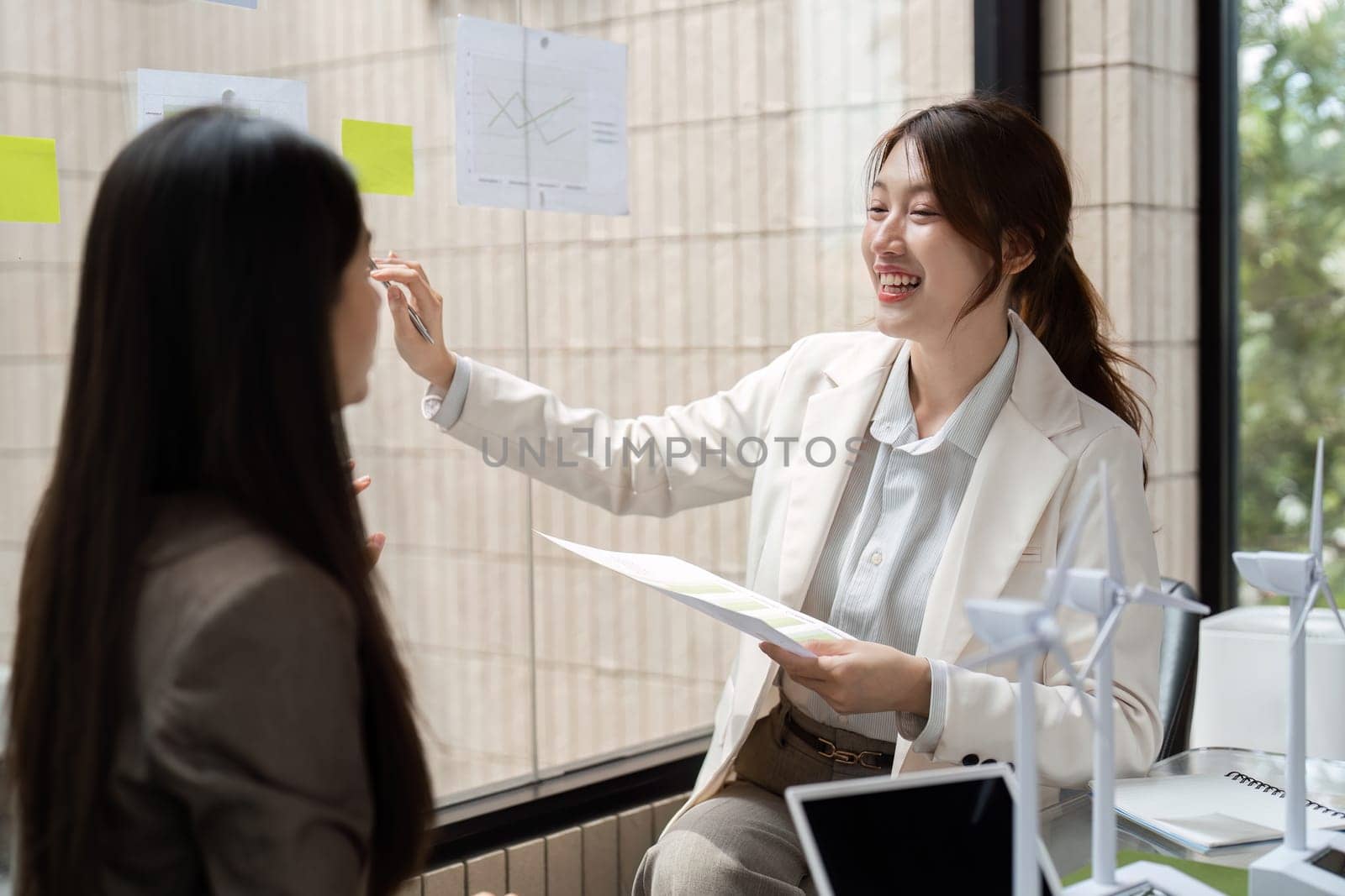 A dynamic conversation unfolds as talented professionals explore strategies to enhance sustainability in their organization, promoting eco-friendly practices.