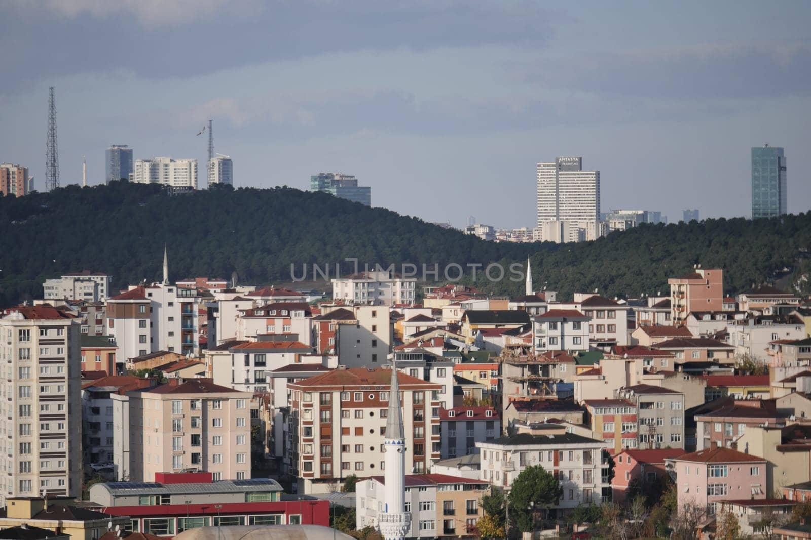 Residential buildings contrast against hills in a dynamic urban setting.