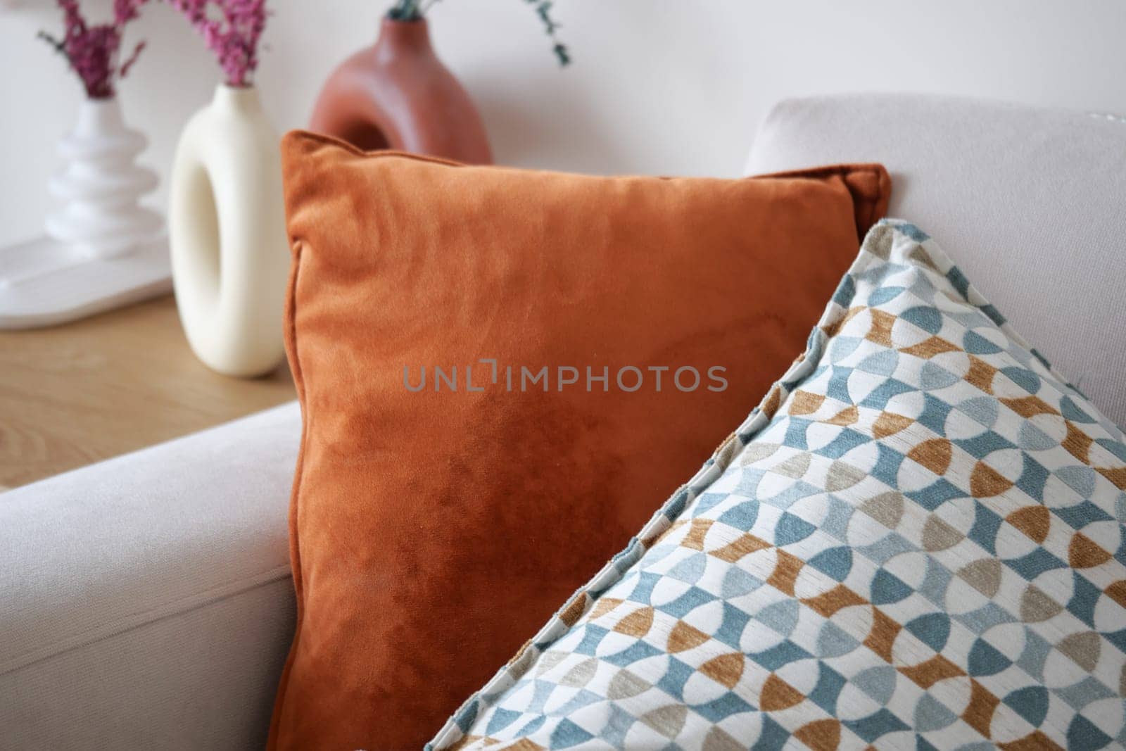 A cozy living space with colorful pillows and decorative ceramics.