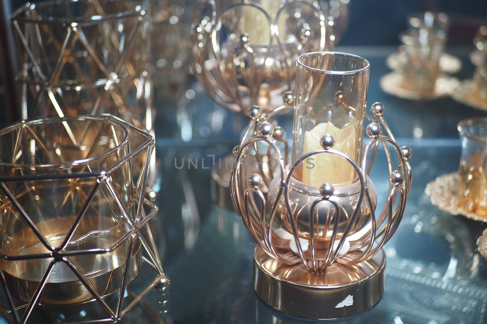Decorative candle holders showcase intricate designs in a bright space.