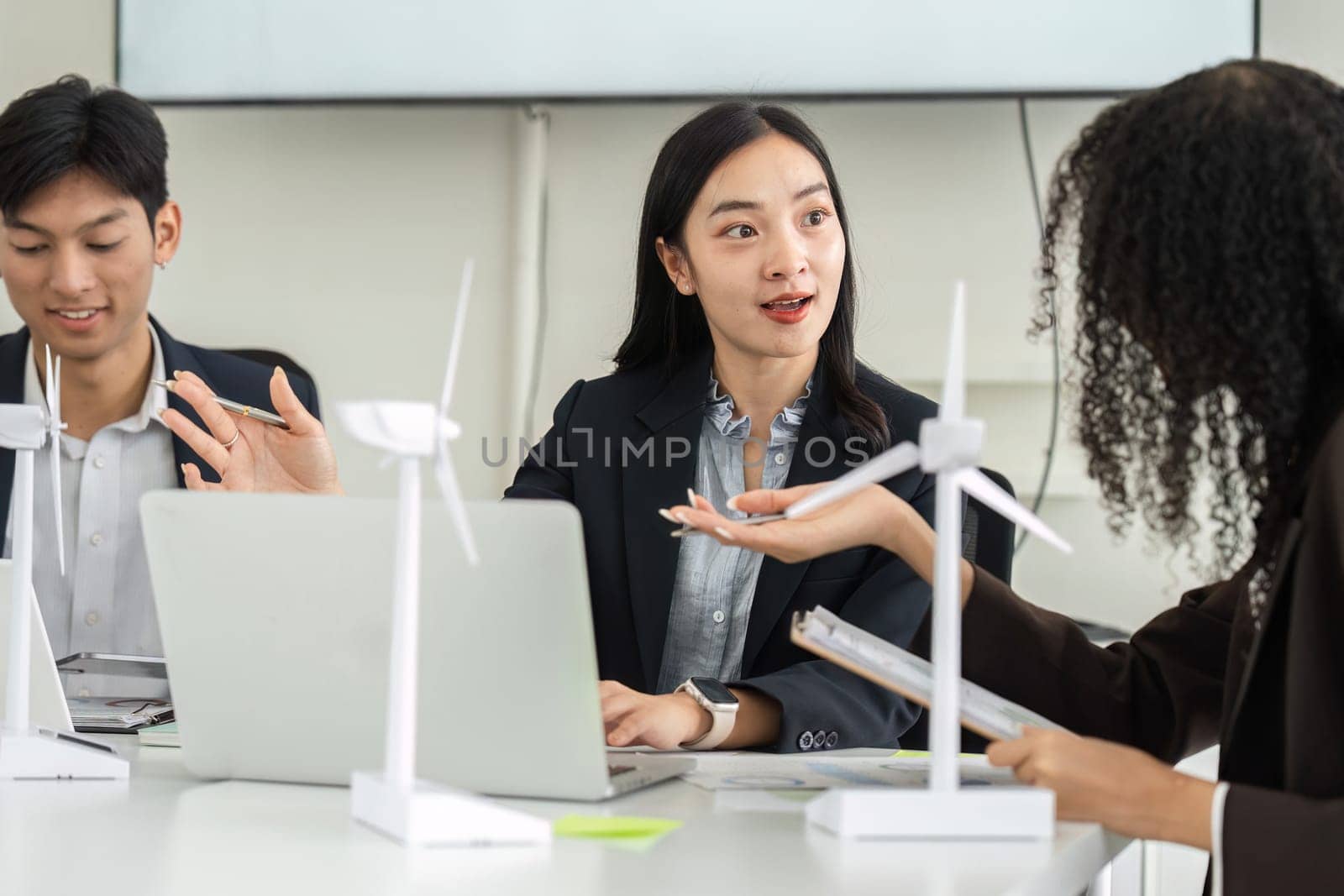 Team members engage in a lively discussion about innovative sustainable strategies, highlighting the importance of collaboration in addressing environmental challenges.